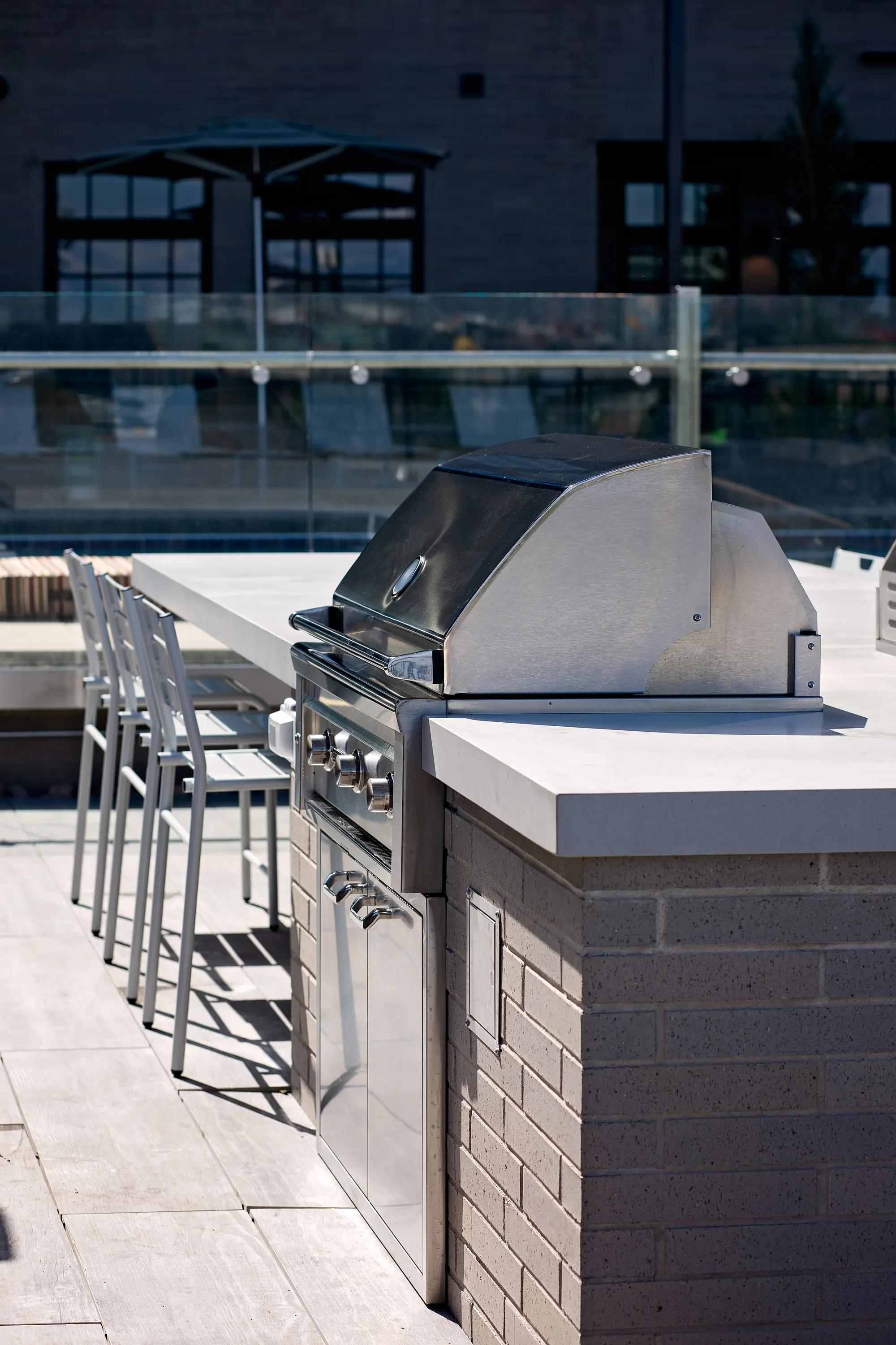 Outdoor courtyard with grilling areas with lounge seating modera art park denver co