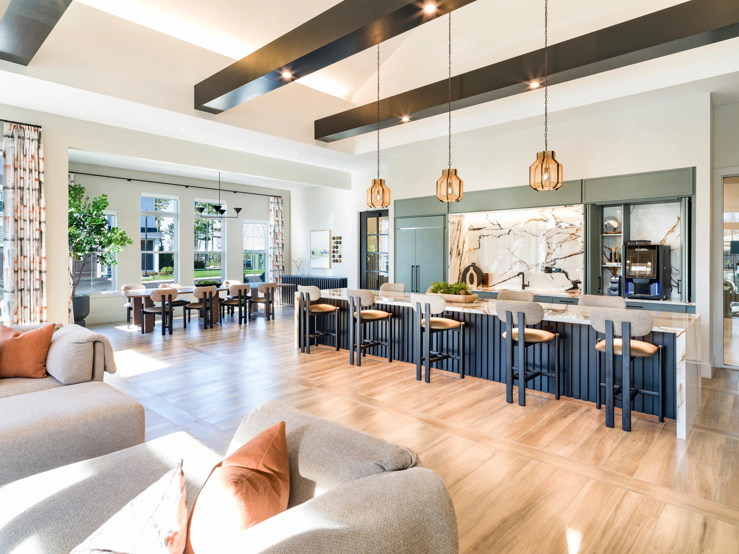 demonstration kitchen in clubhouse with seating and hdtv modera south shore apartment homes for rent in marshfield ma