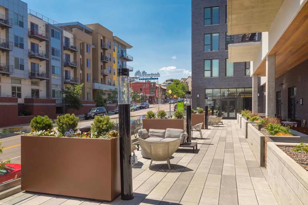 Outdoor patio just above street level offers seating nooks and lots of sunshine modera lohi apartments in denver co