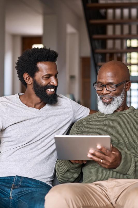 modera higley commons older mature father and younger son scrolling on tablet