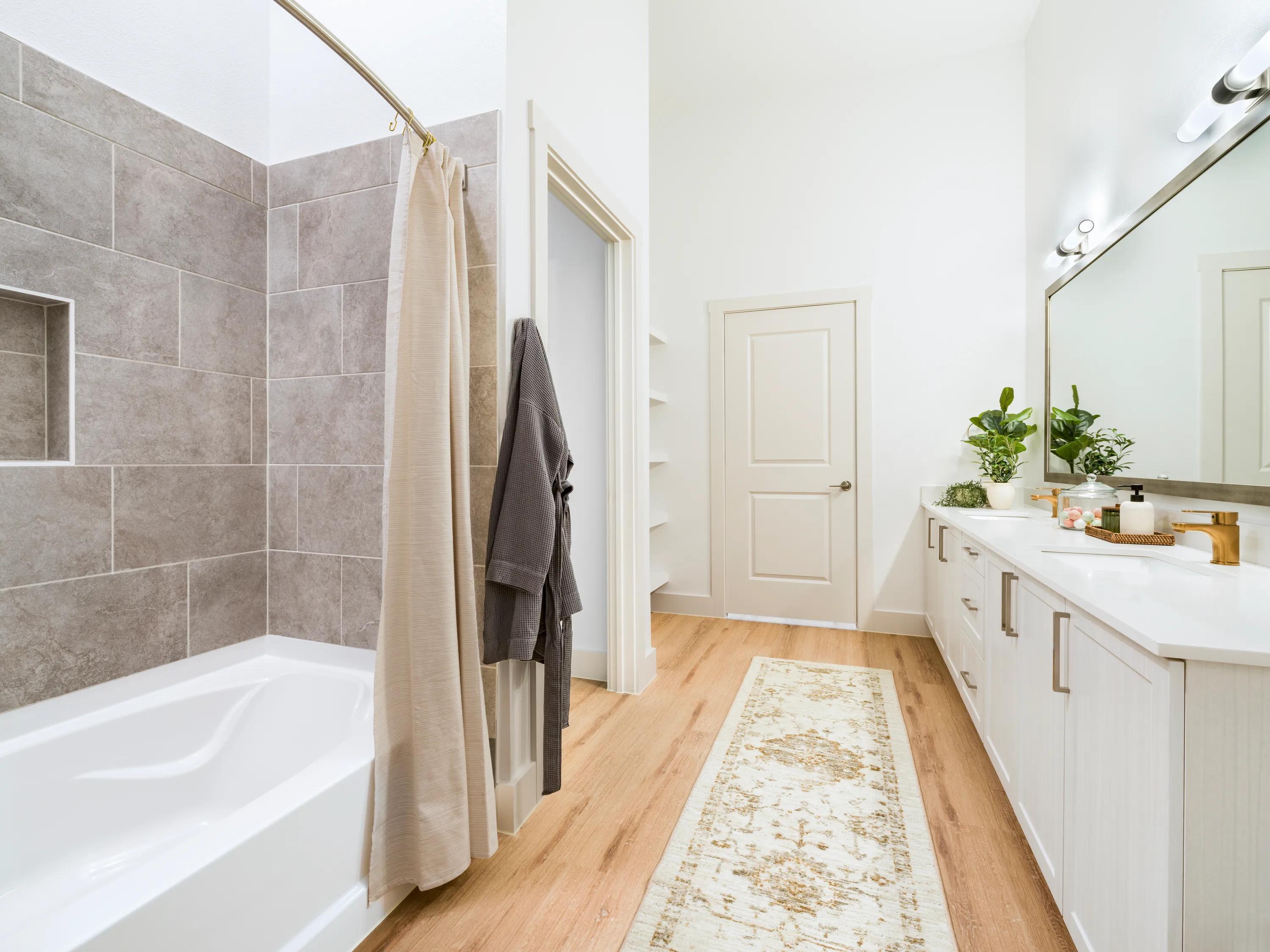 spa inspired bathroom with tile surround shower and double vanity modera walsh heights apartments aledo tx