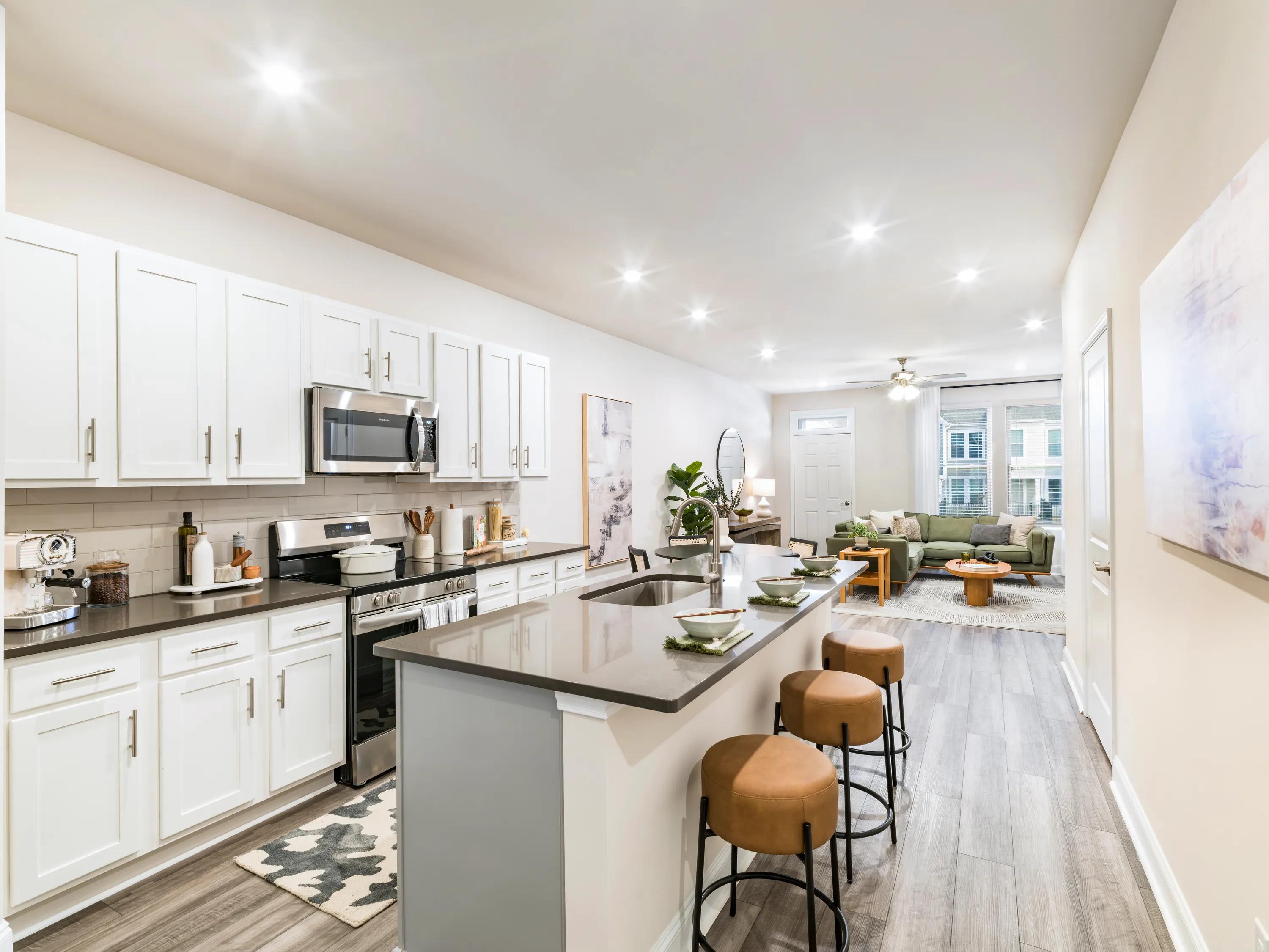 kitchen space with island seating and white cabinetry amavi mooresville single family homes for rent in nc