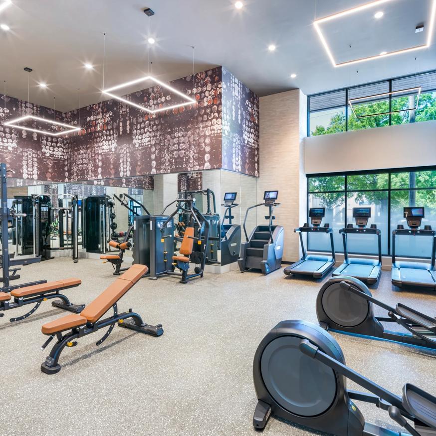 gym with cardio and weight equipment featuring high ceilings  modera loso apartment homes for rent in charlotte nc