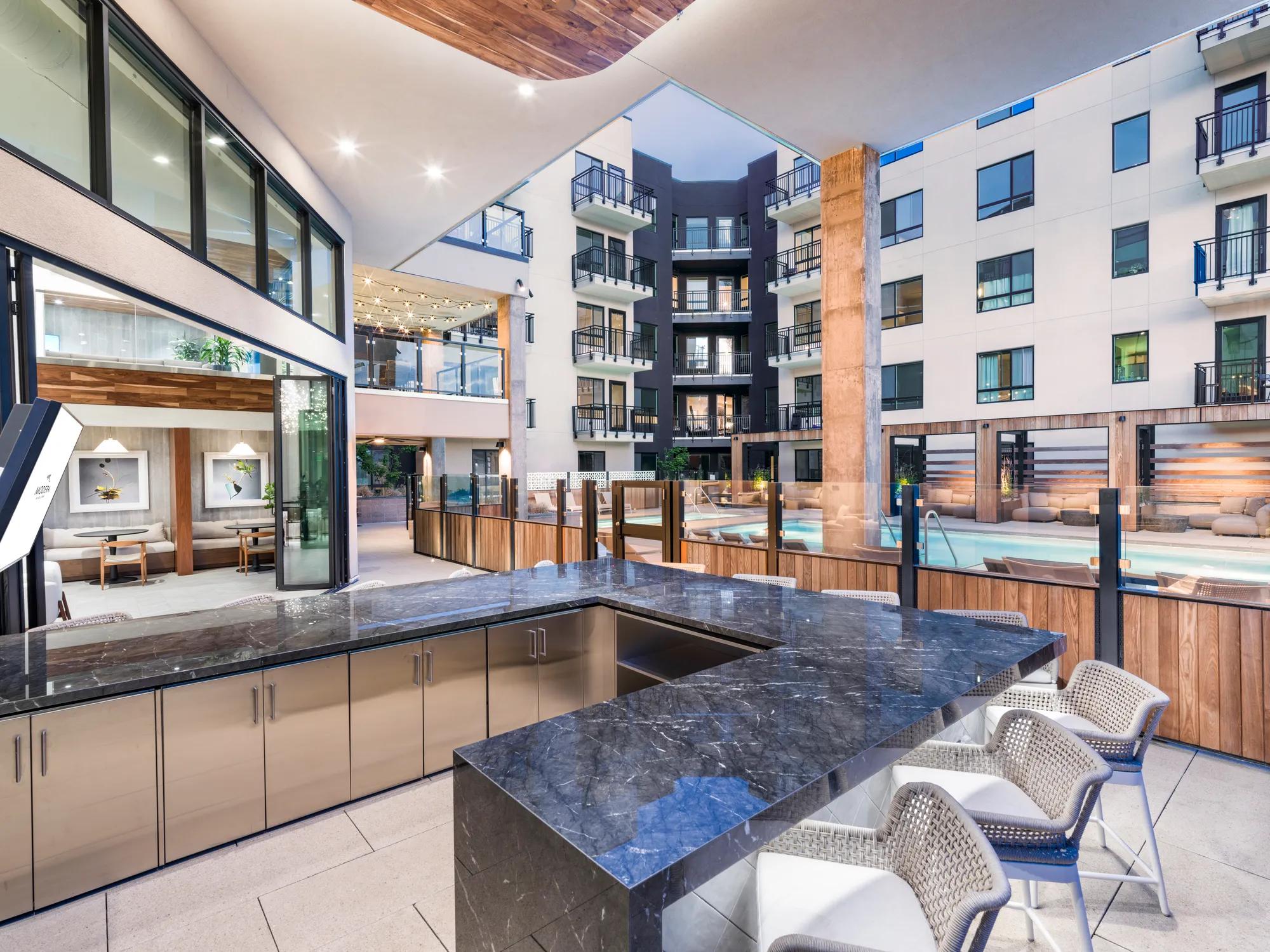 outdoor demonstration kitchen with bar seating countertop modera golden triangle apartment homes for rent in denver co