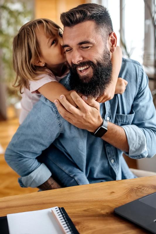 father and daughter smiling and laughing together