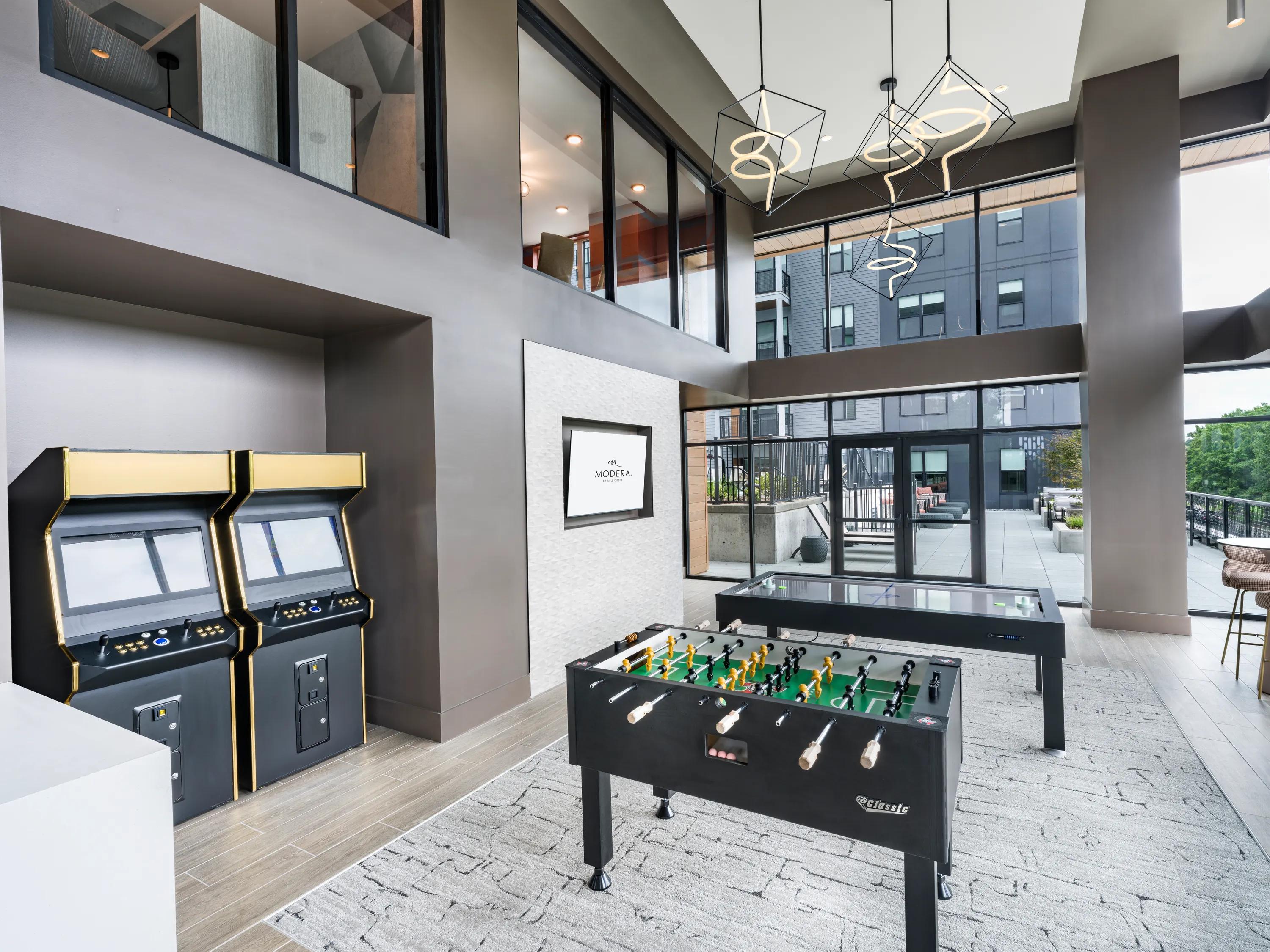 Game room with foosball, air hockey, and arcade games modera loso