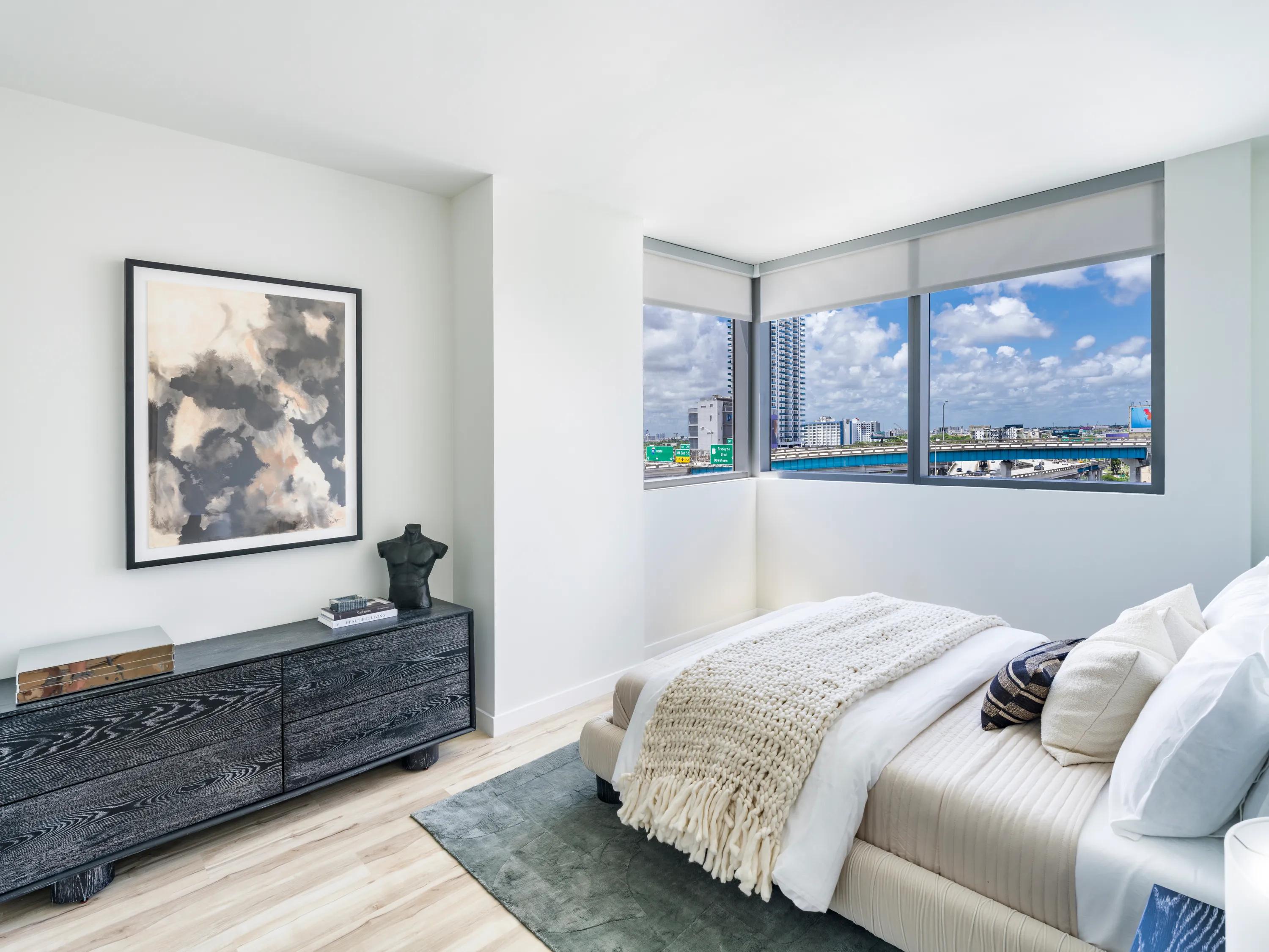 bedroom with large windows looking towards city modera riverside apartment homes for rent in miami fl