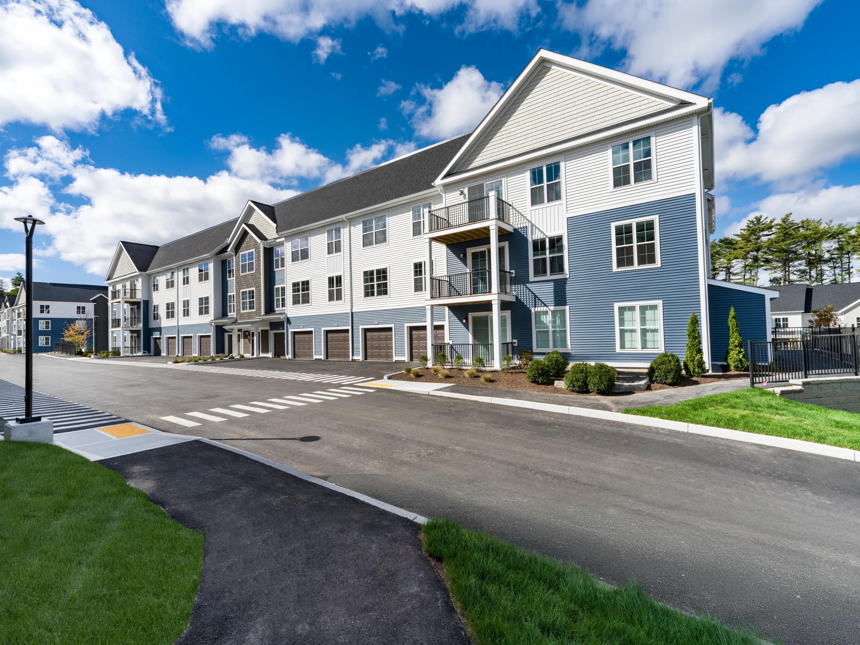 exterior street view with parking and garage modera south shore apartment homes for rent in marshfield ma