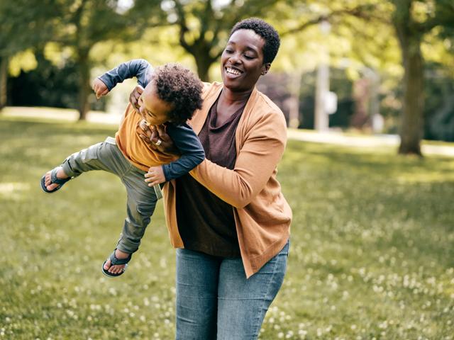 mother and young toddler playing outside in a park near modera needham apartments in needham ma