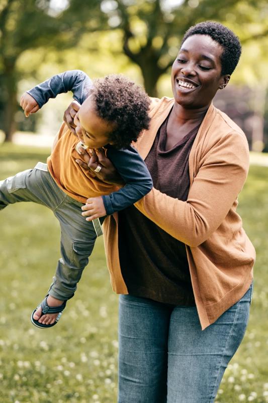 woman and son playing in an outdoor park near modera beaverton apartments in portland