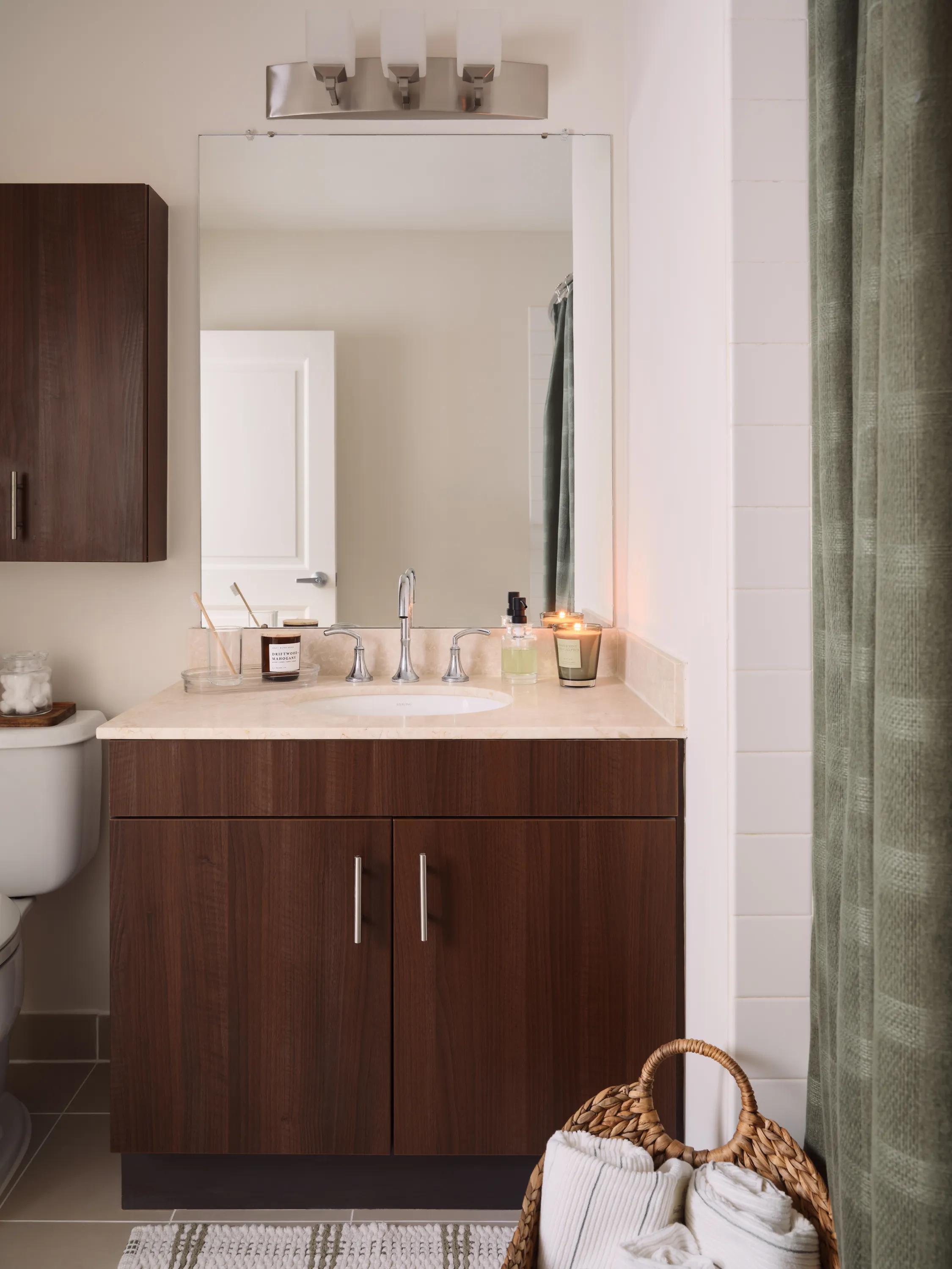 bathroom with green shower curtain and light vanity countertops metropolitan at 40 park apartment homes for rent in morristown nj