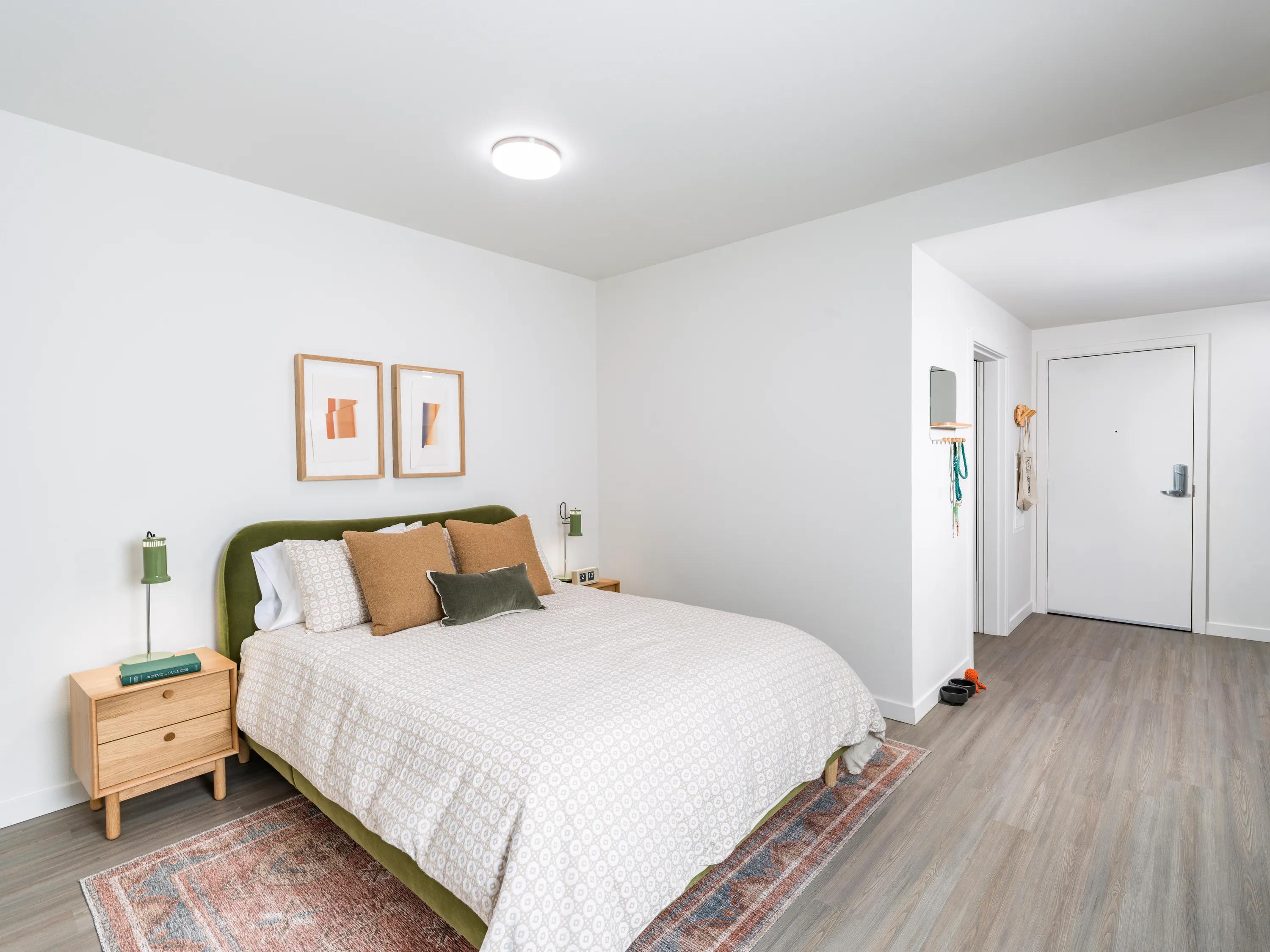 Spacious bedroom with hardwood style flooring