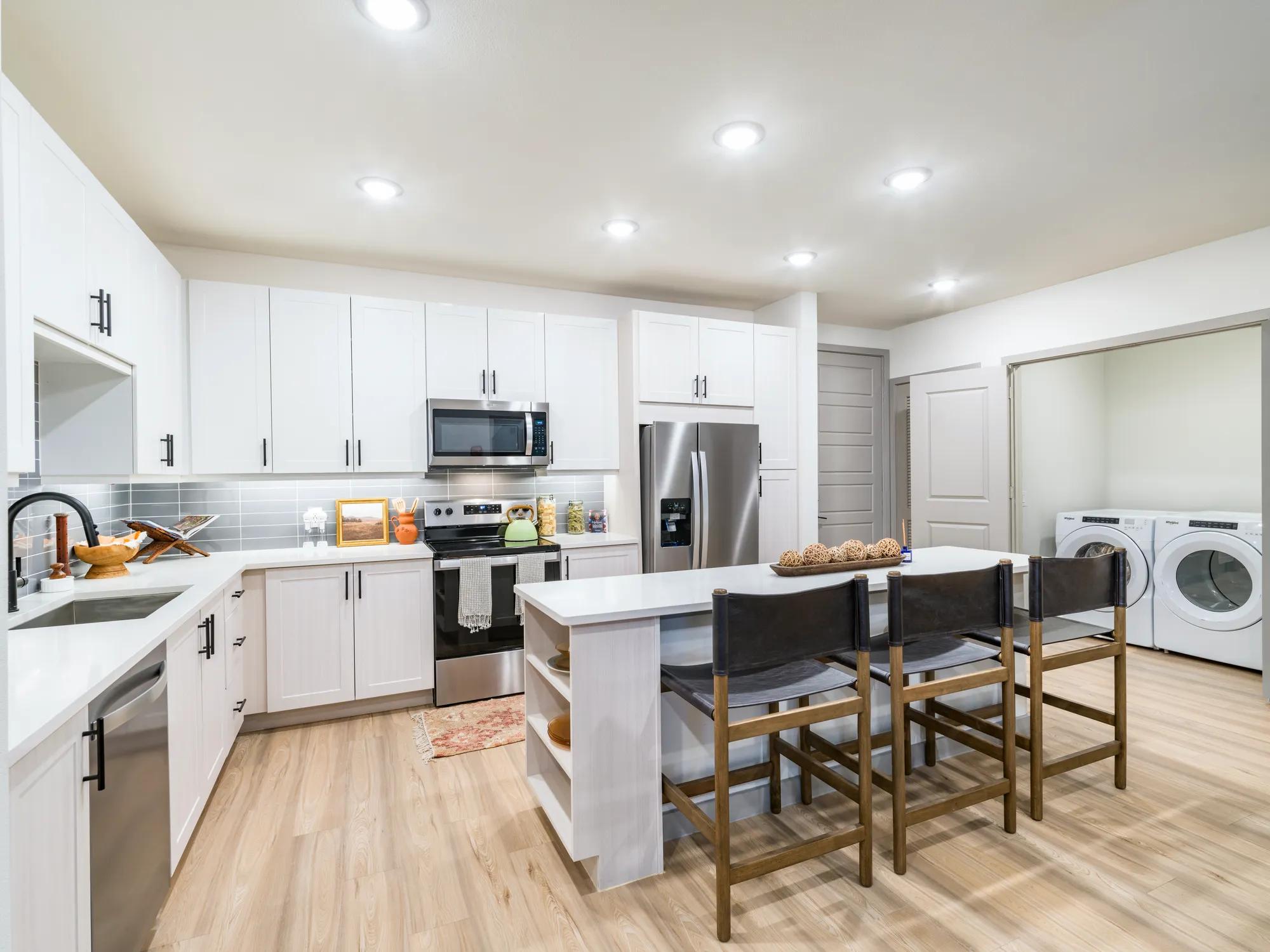 kitchen view with large island for storage and seating overlooking living room