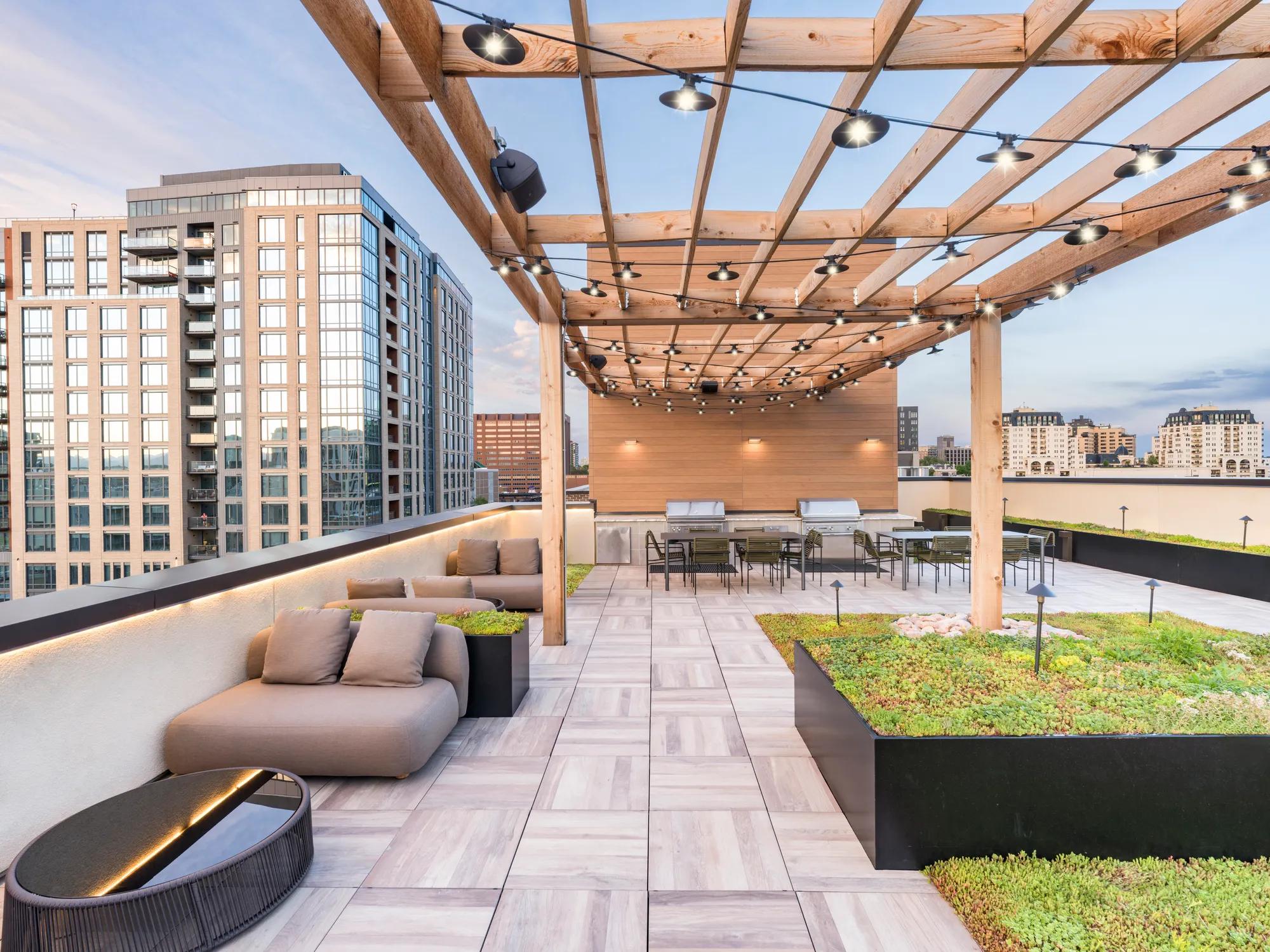 rooftop lounge with greenspace underneath pergola modera golden triangle apartment homes for rent in denver co