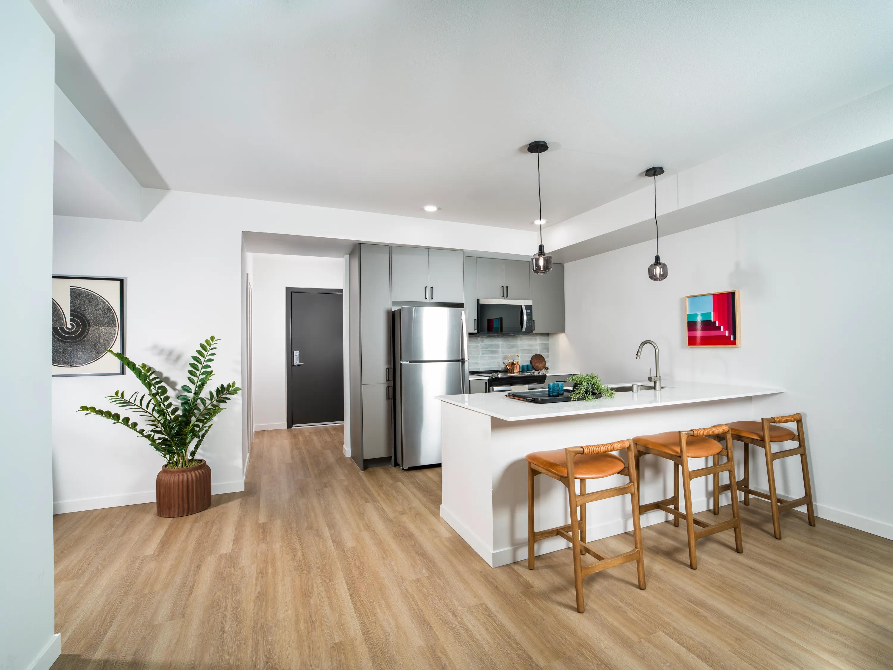 Gourmet kitchens with quartz countertops, 36-inch custom cabinetry with soft close, and under-cabinet lighting