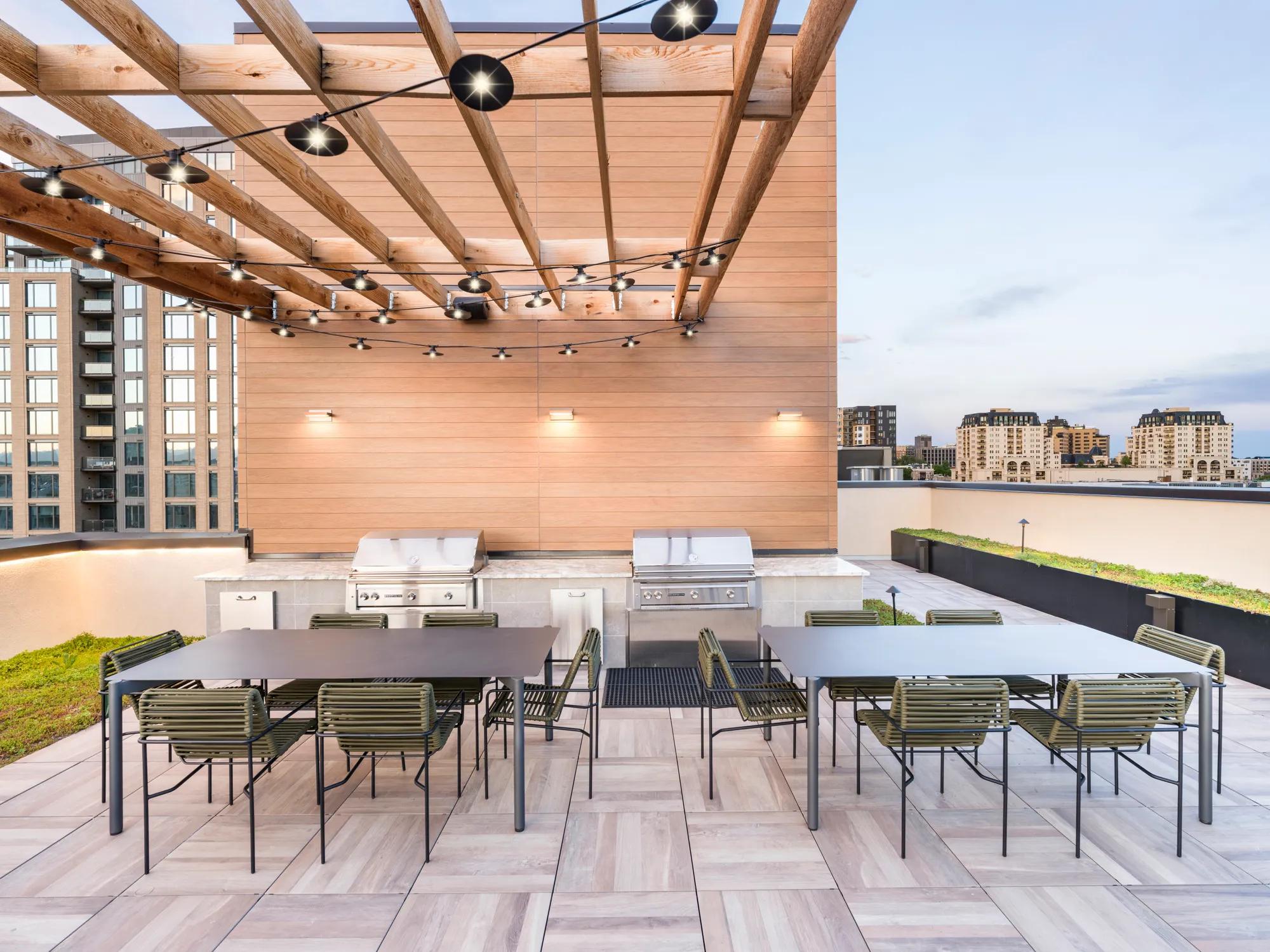 outdoor rooftop bbq area with dining tables modera golden triangle apartment homes for rent in denver co