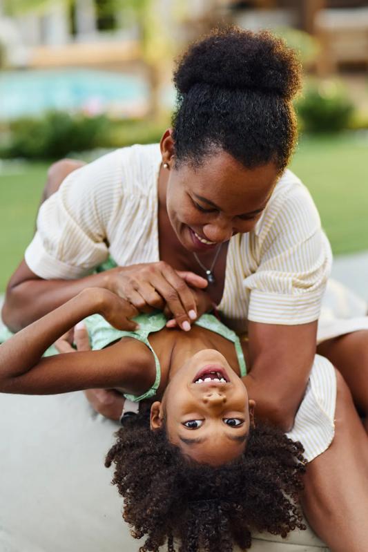woman with child smiling and playing modera river north apartments in denver co
