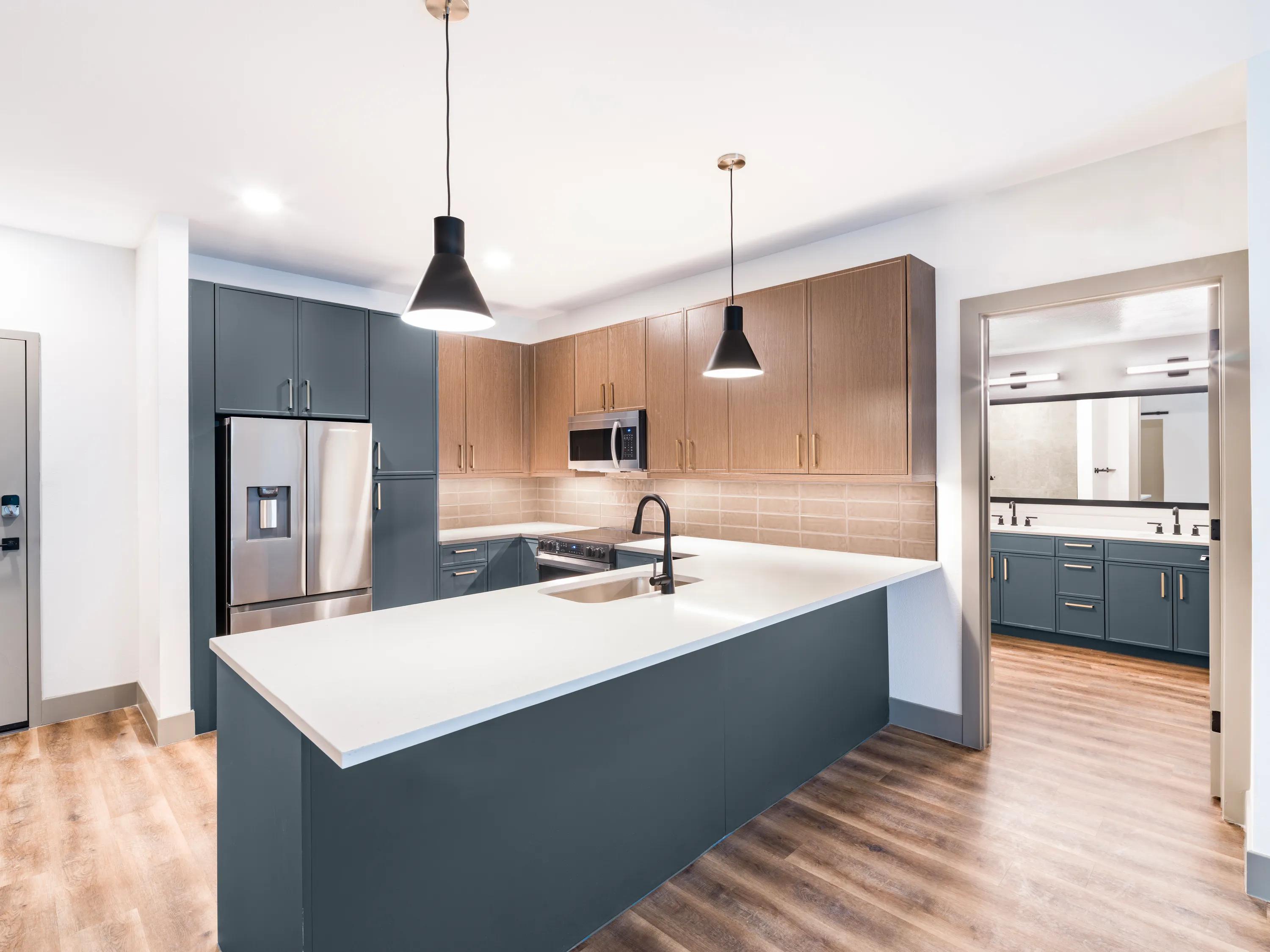 kitchen with blue and brown two toned cabinetry modera chandler apartments for rent in chandler az