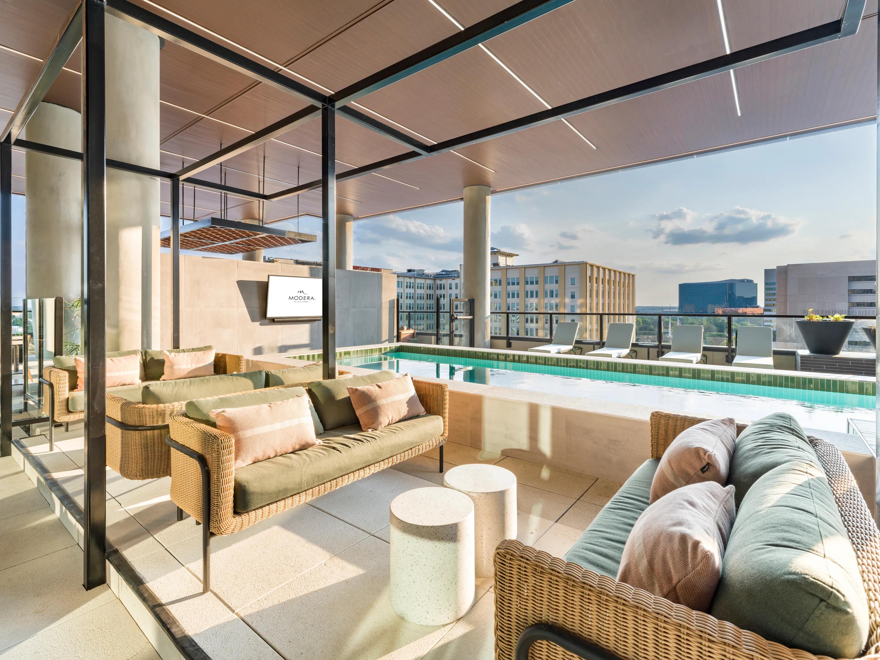 rooftop deck and amenity space with fireplace and demonstration kitchen modera st paul apartment homes for rent