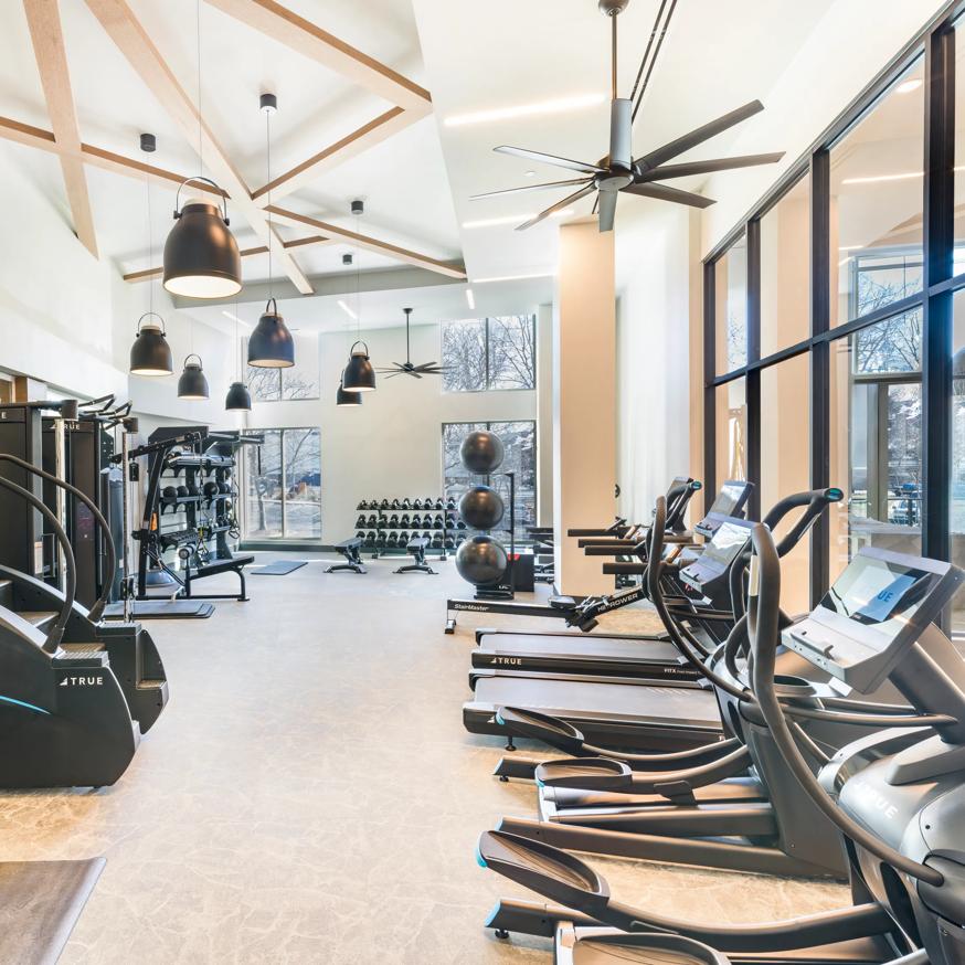 man working out on elliptical machine in gym modera falls church apartment homes for rent in va