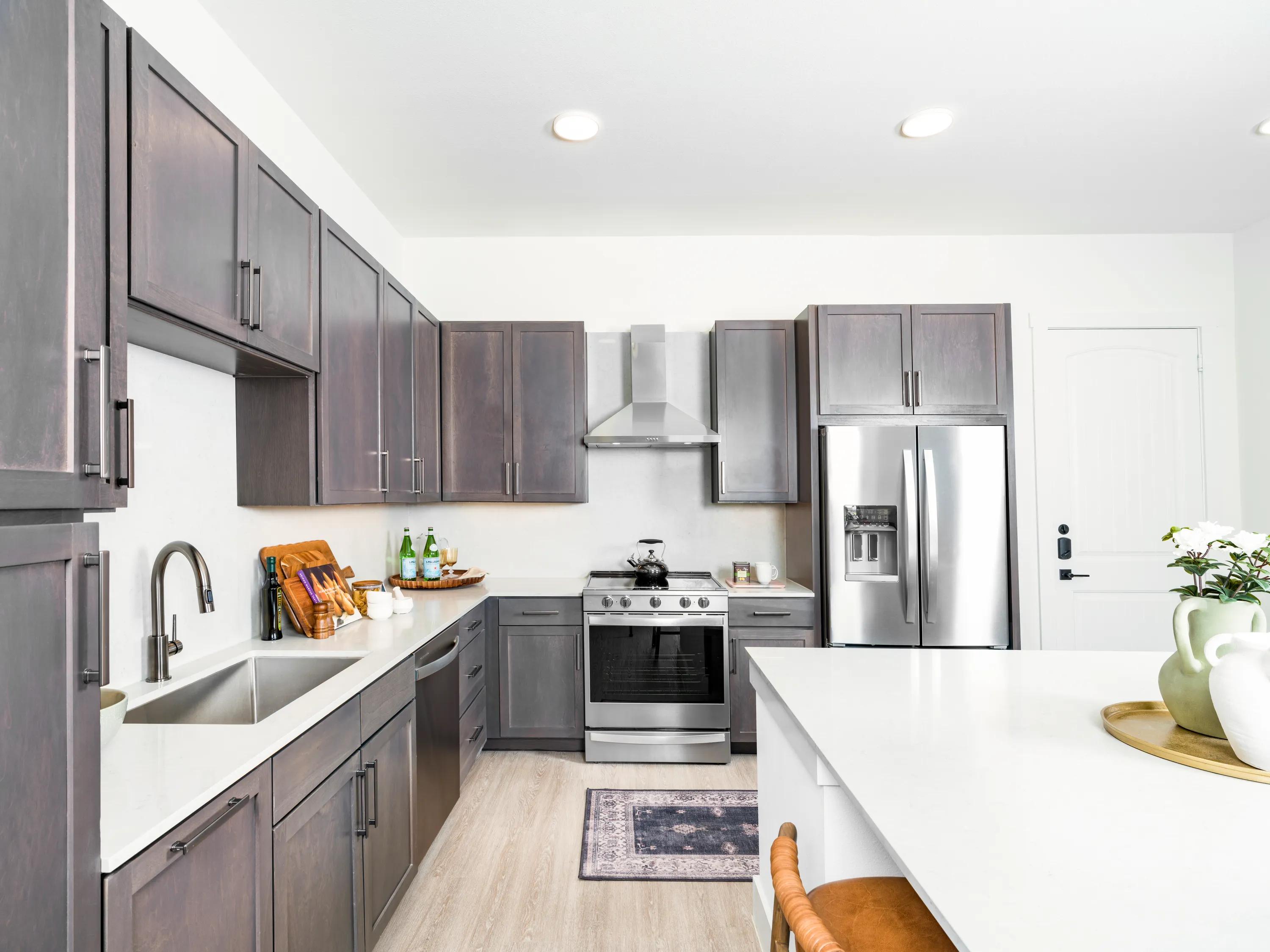 premium home kitchen with wood style cabinetry and stainless steel appliance package modera trailhead apartment homes for rent in dallas tx