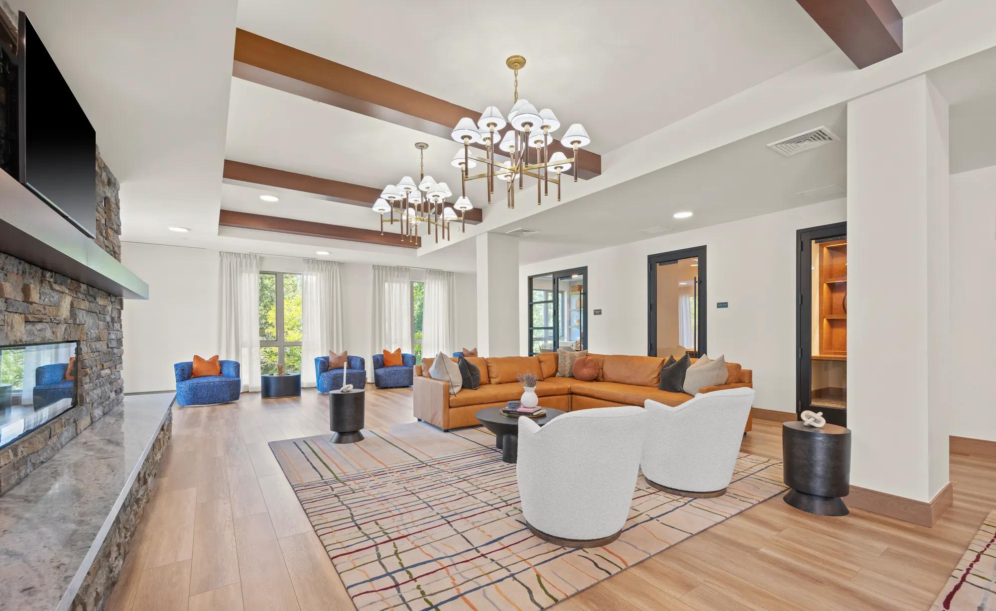 clubroom with tasteful seating and hdtv above fireplace at modera newton apartment homes for rent in ma