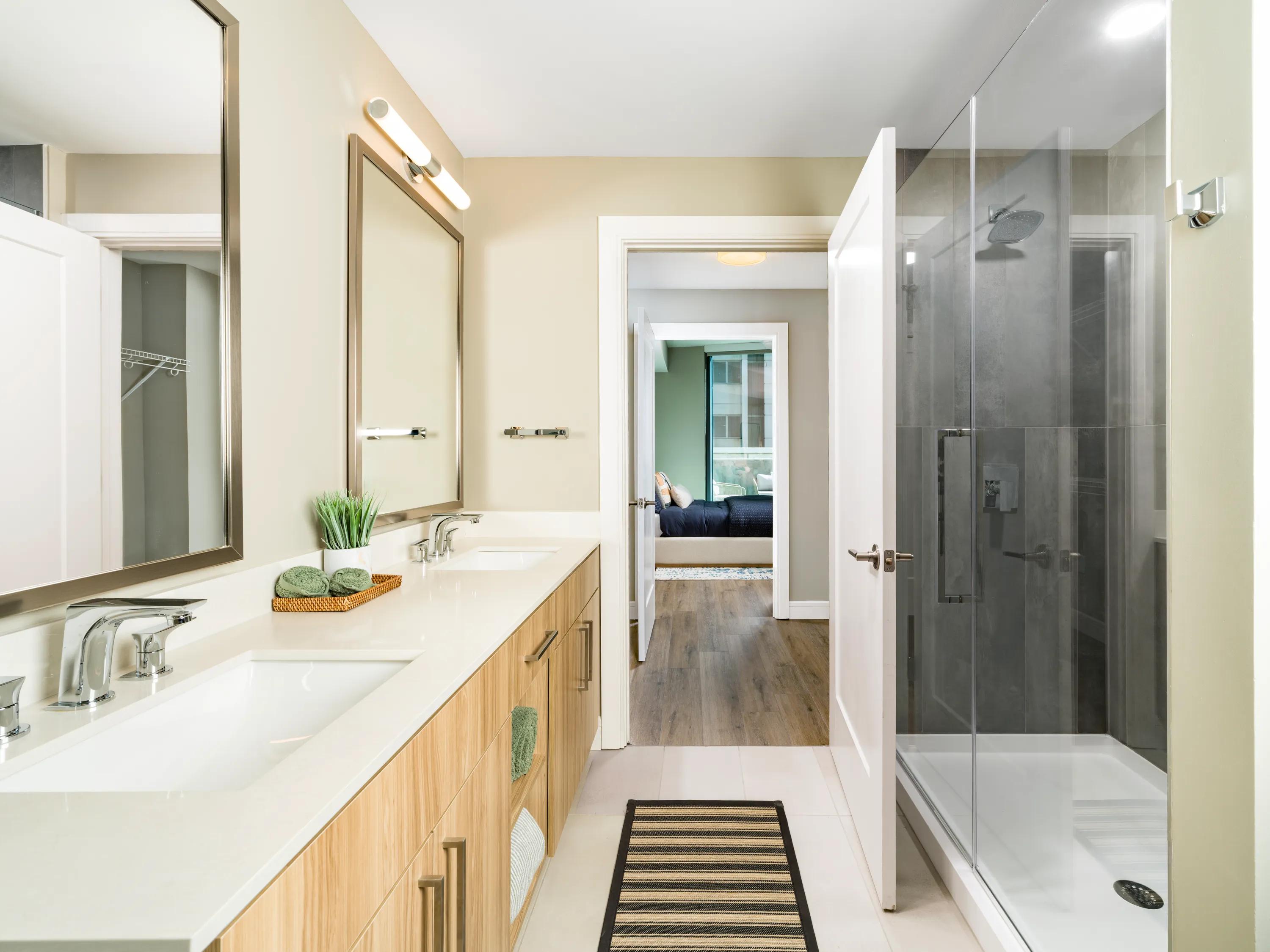 Frameless glass showers with floor-to-ceiling tile surrounds*