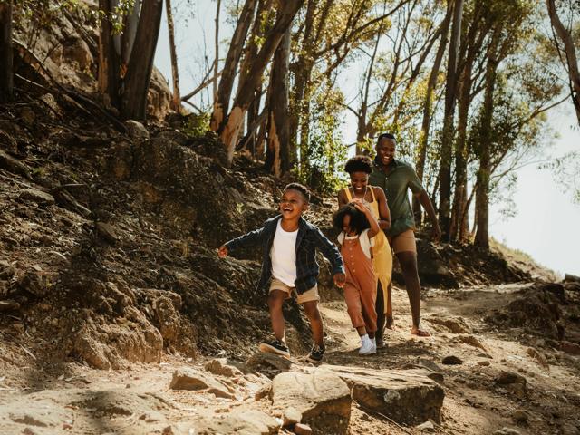 family walking on trail smiling near lady bird johnson wildflower center near alister oak hill