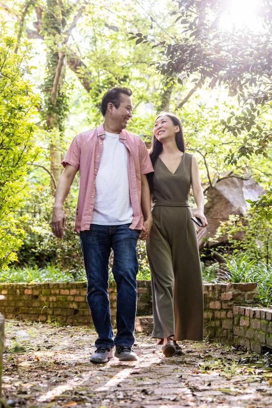 Mature Man and Woman walking outdoors together holding hands