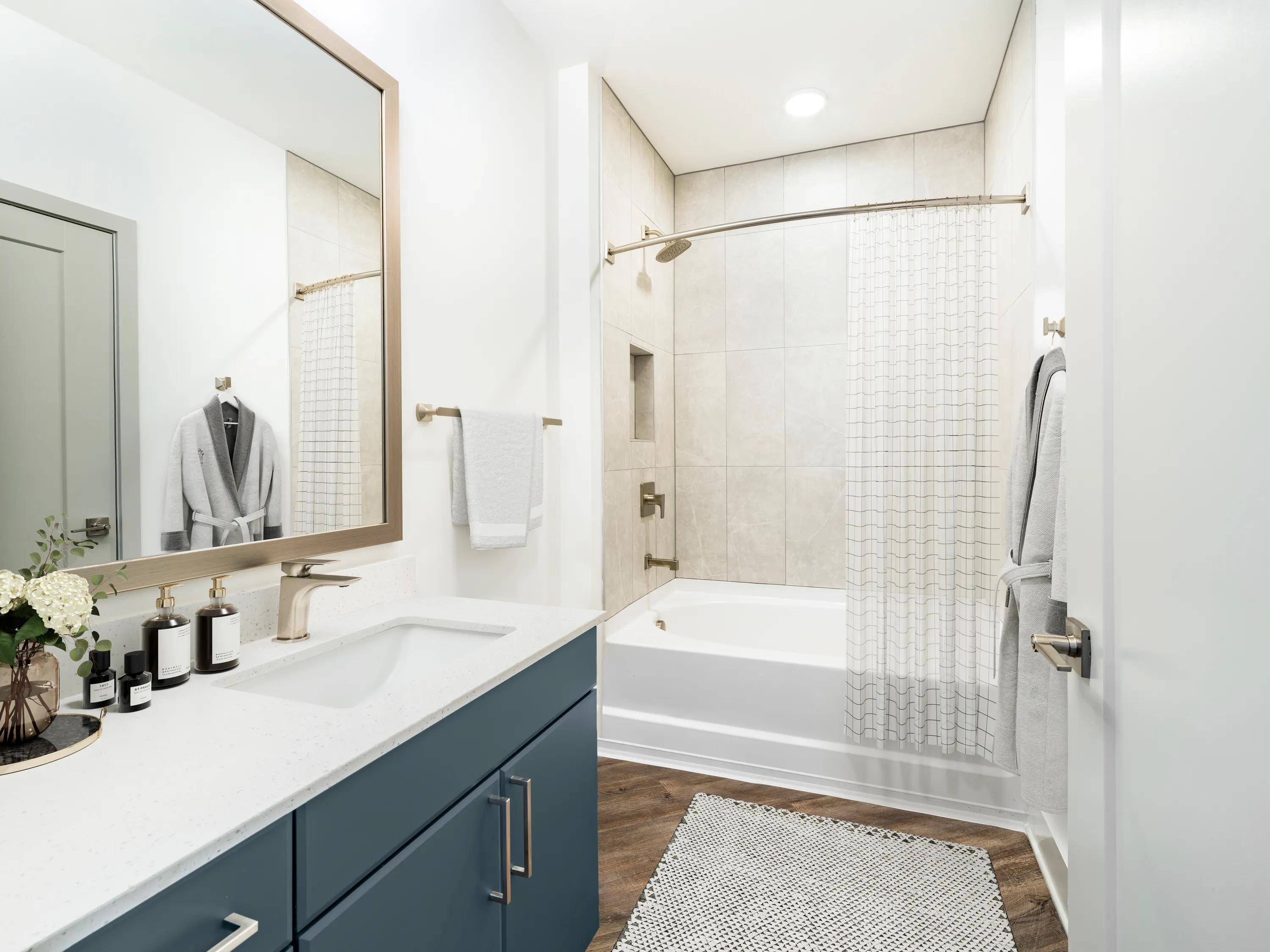blue cabinetry in spa like bathroom with tub modera westside trail apartment homes for rent in atlanta ga