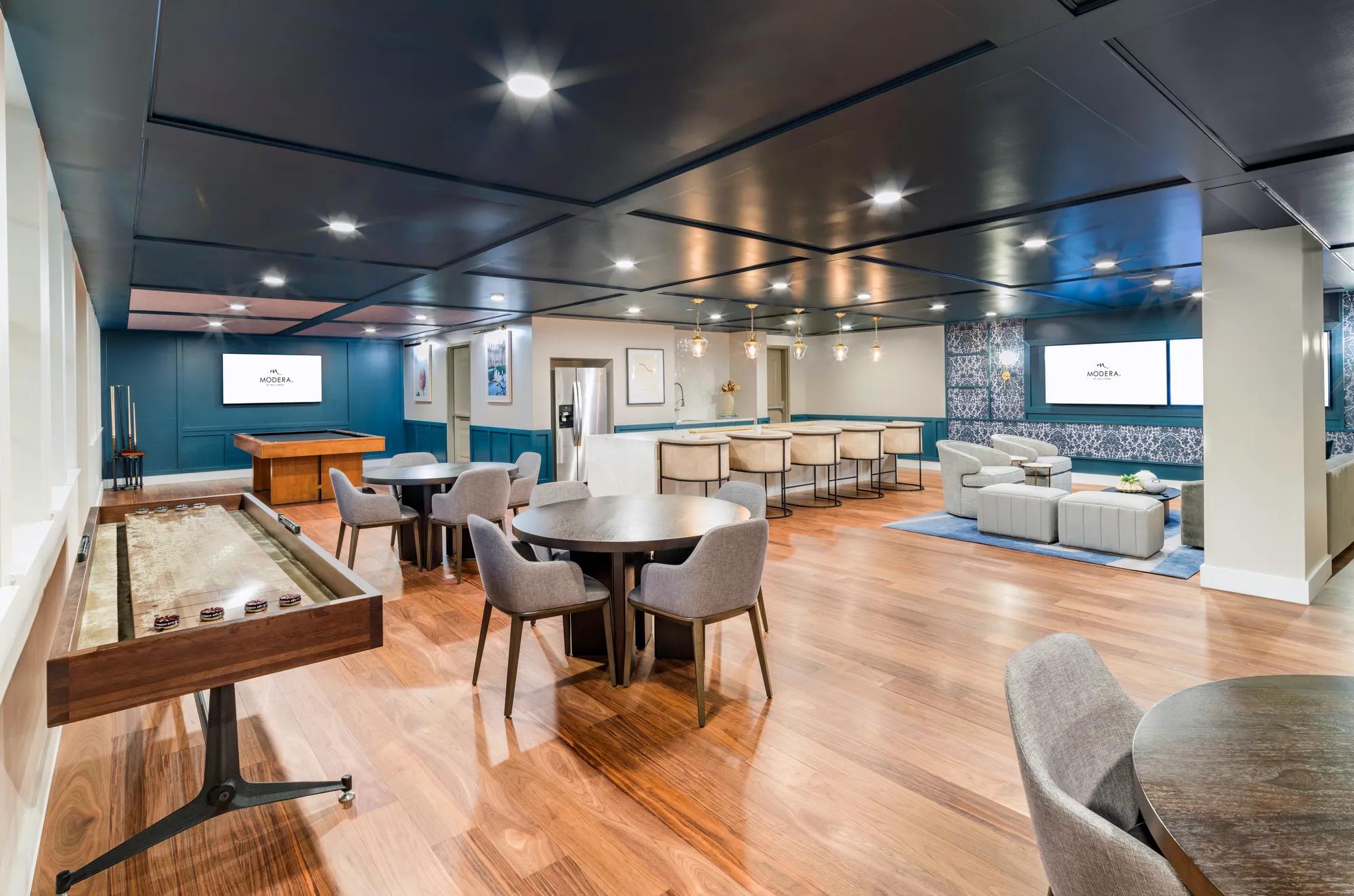 gaming lounge featuring pool tables, bar, tv areas, and plenty of seating