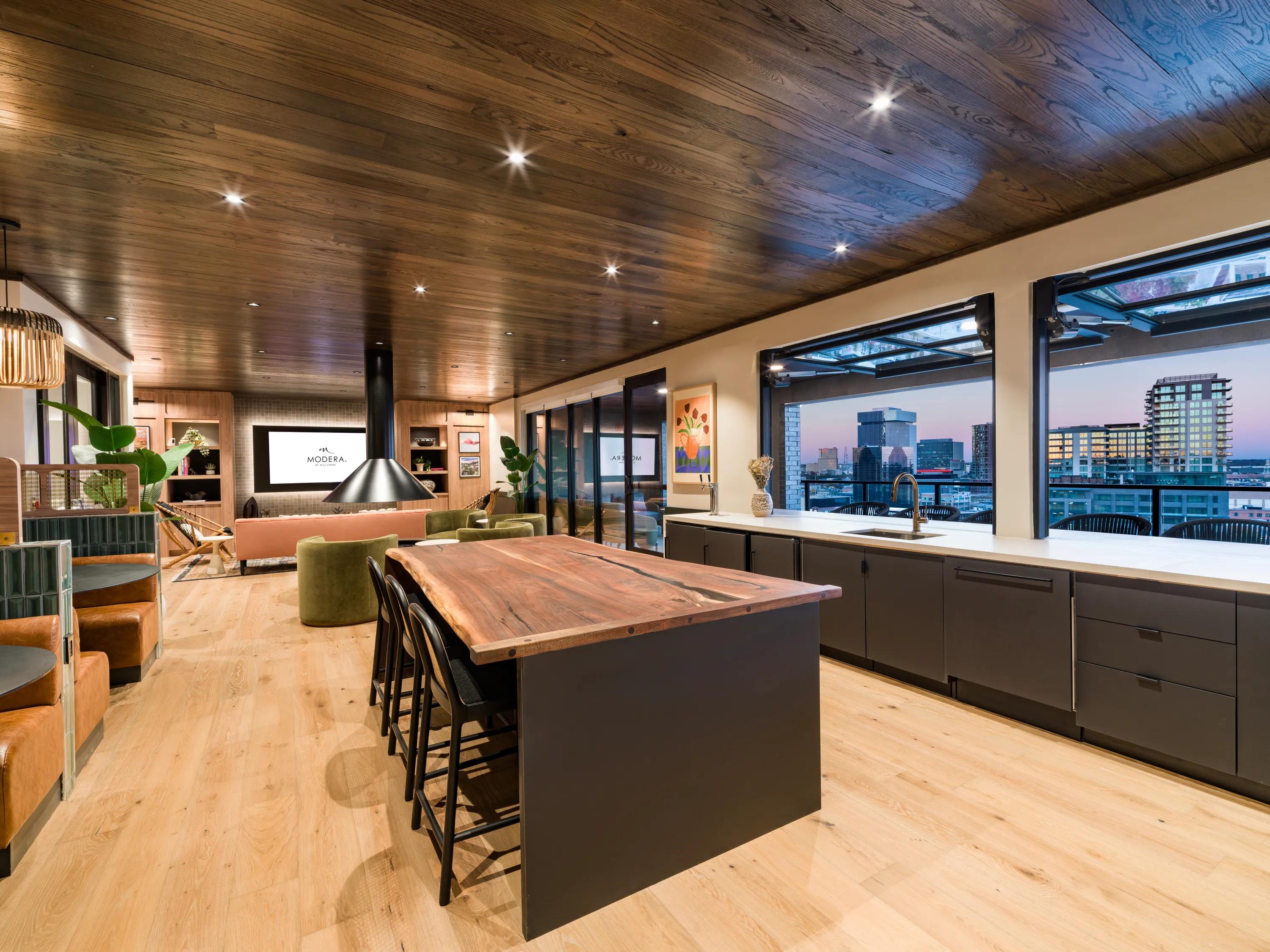 lounge with kitchen area and downtown views modera st paul apartment homes for rent
