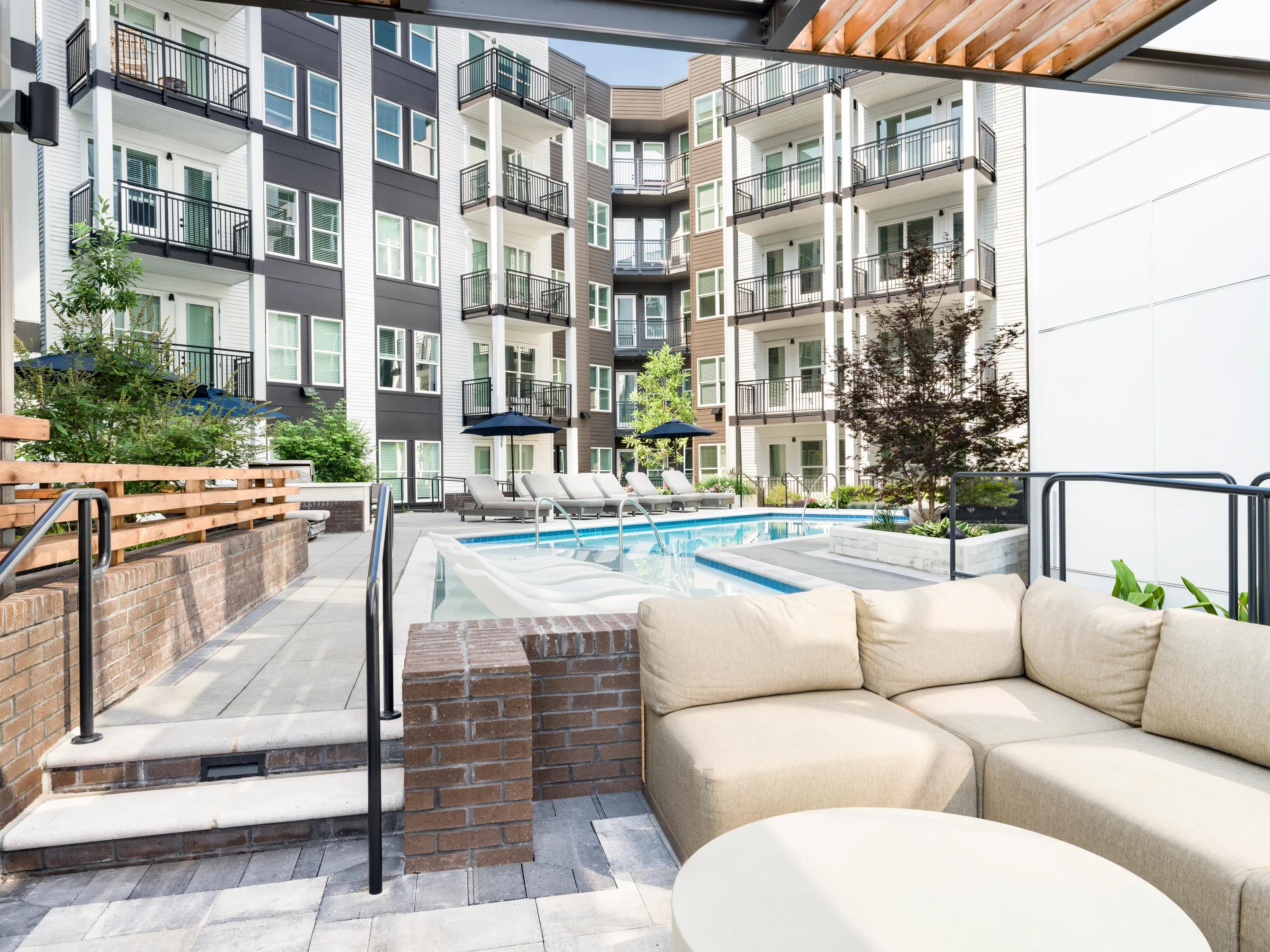 Covered outdoor lounge overlooking the pool modera westside trail apartment homes for rent in atlanta ga