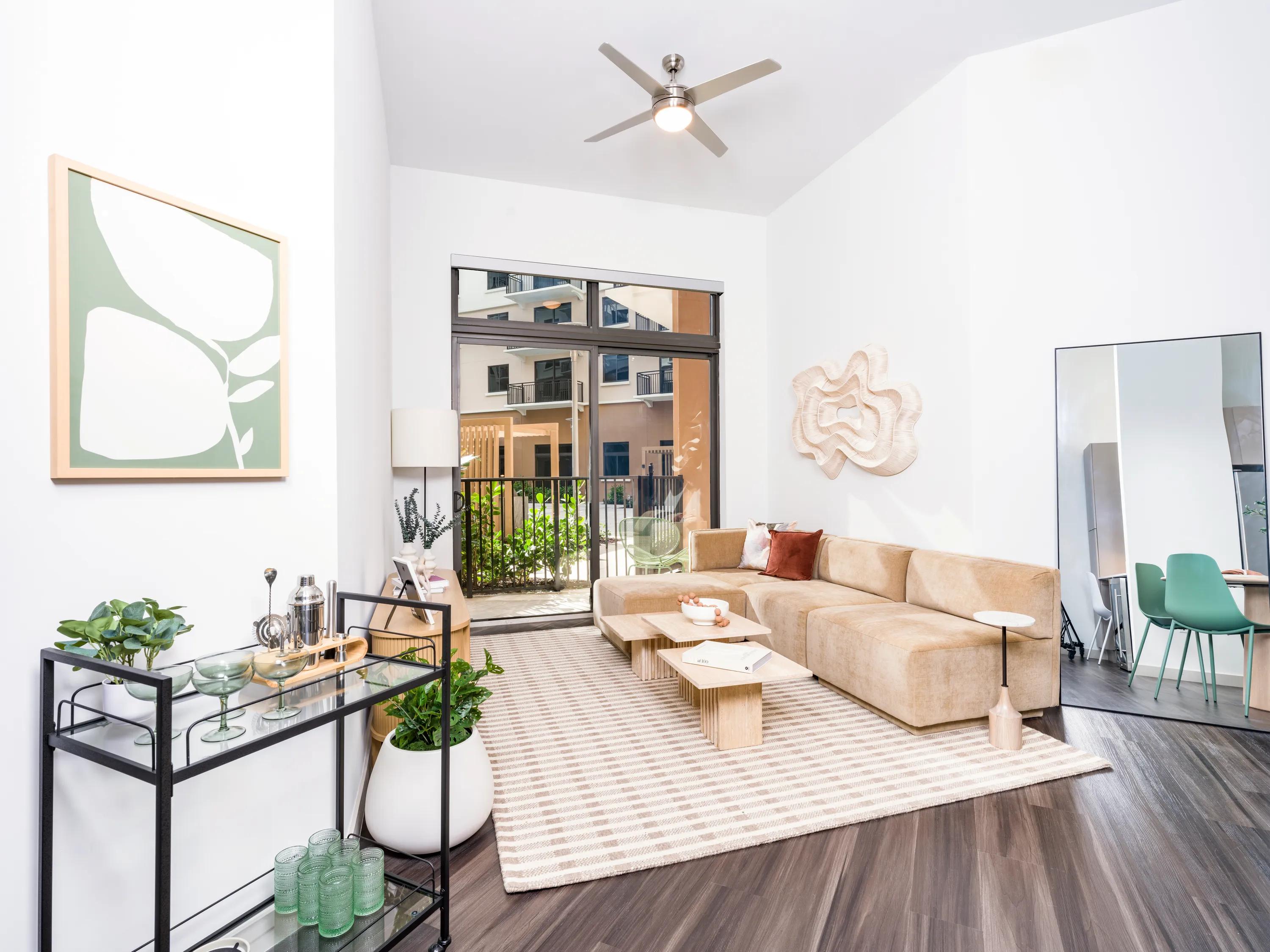 living room with furniture looking into kitchen at modera academical village apartment homes for rent in davie fl