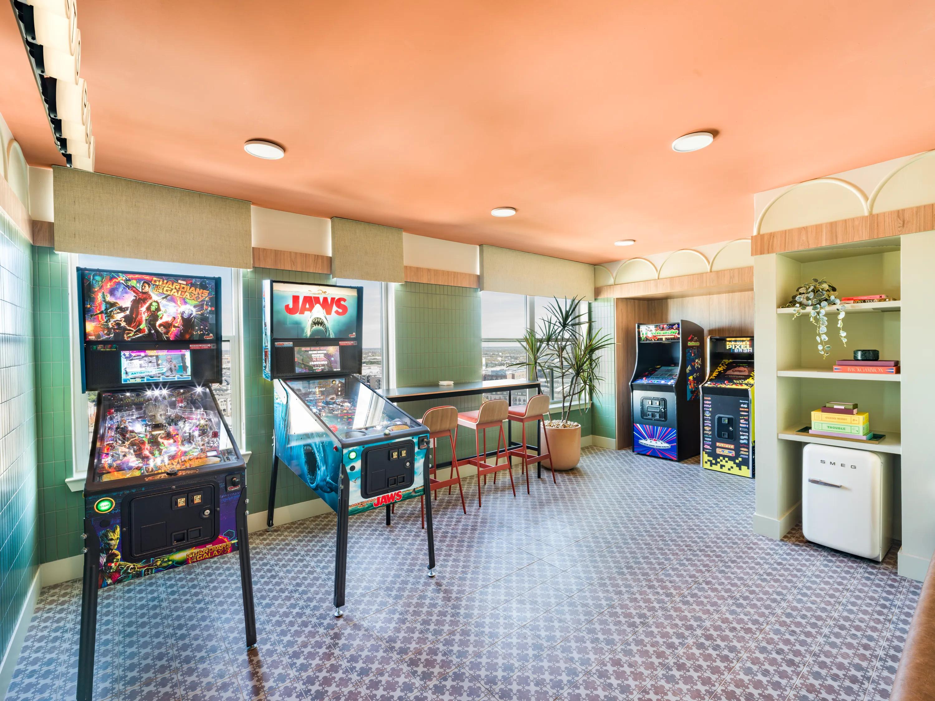 arcade lounge with retro games and smeg mini fridge modera st paul apartment homes for rent