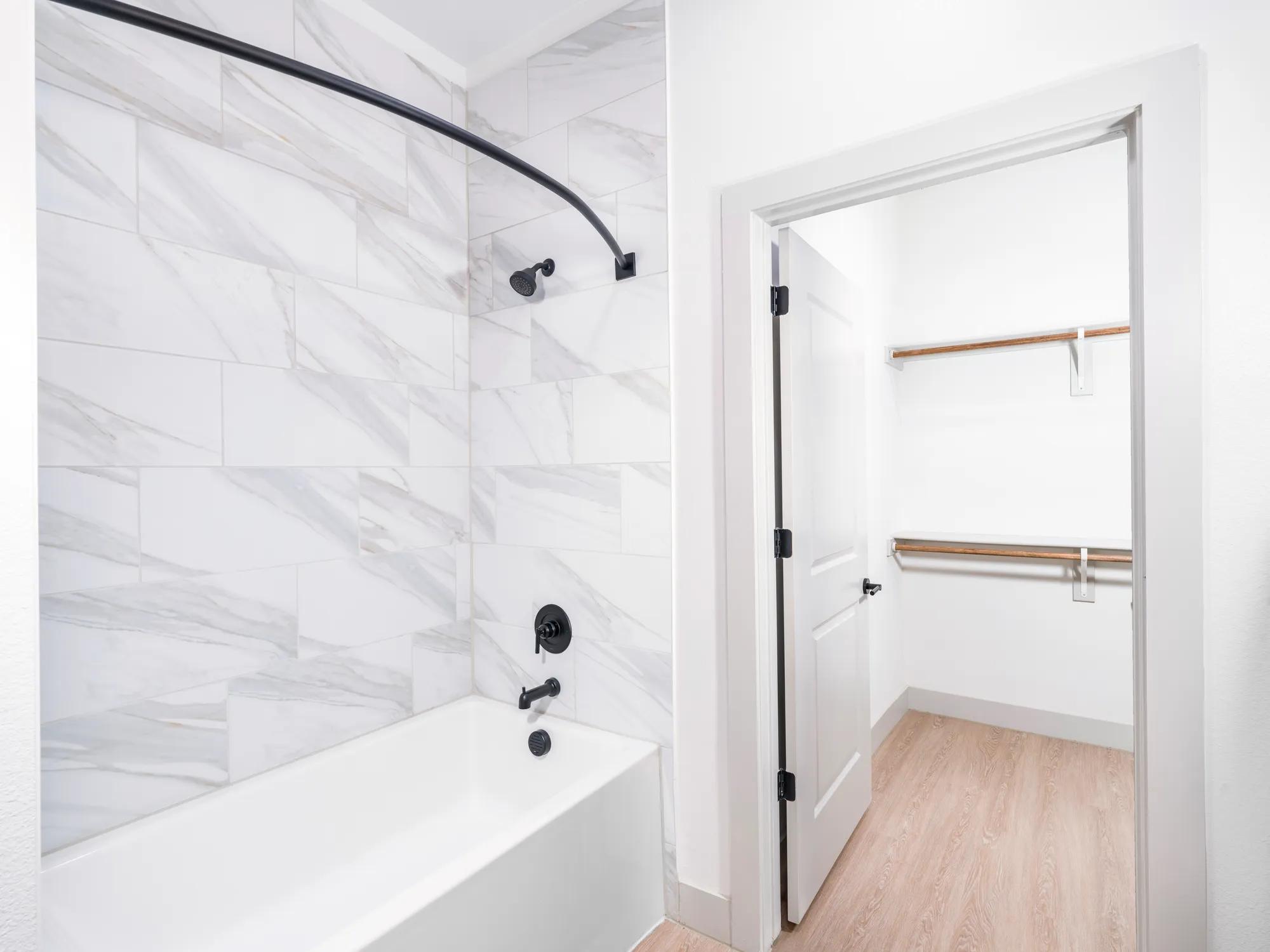 bathtub in bathroom leading into spacious closet modera mckinney ridge apartment homes for rent in tx