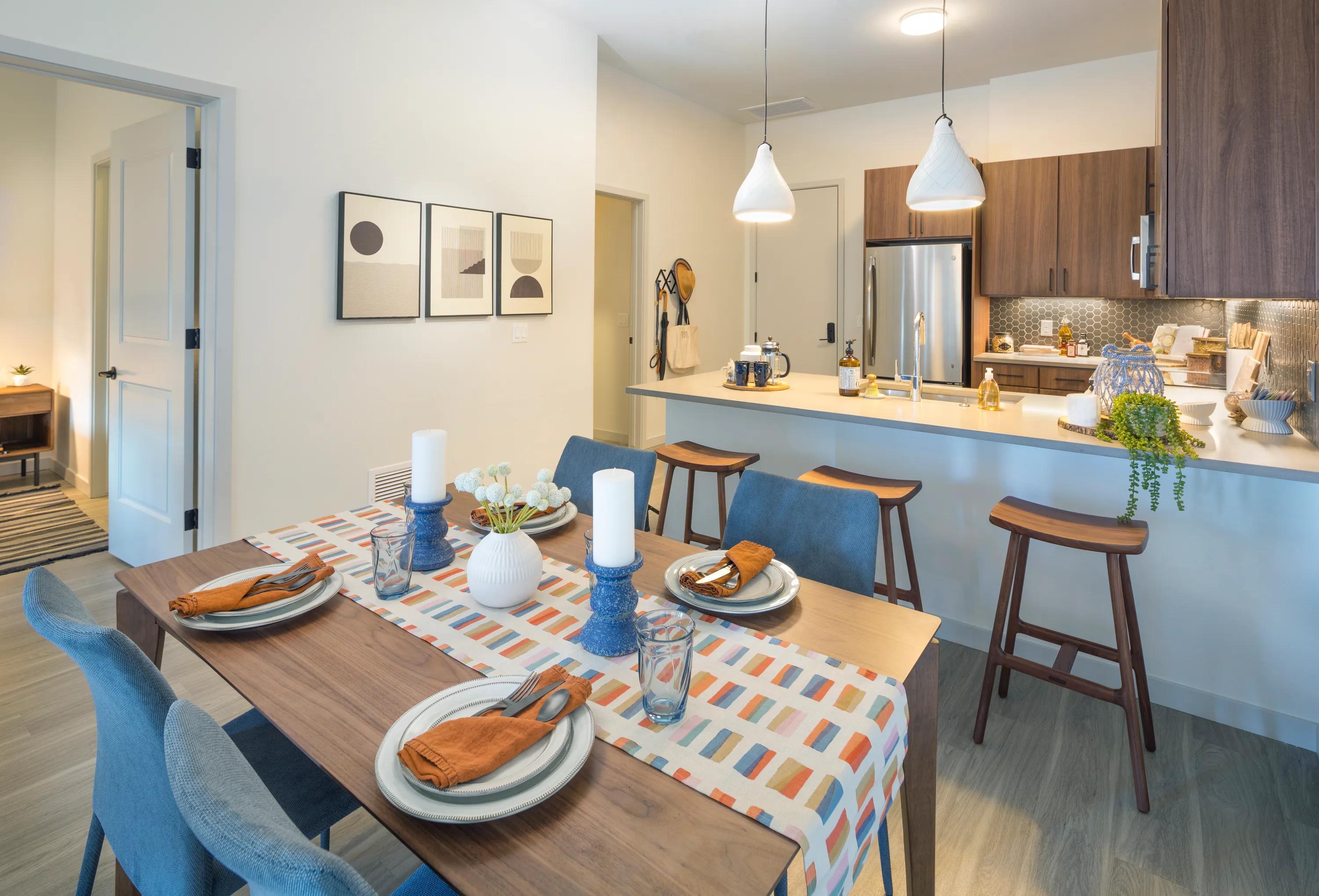Dining area and kitchen  at Modera West Wash Park apartments in Denver.