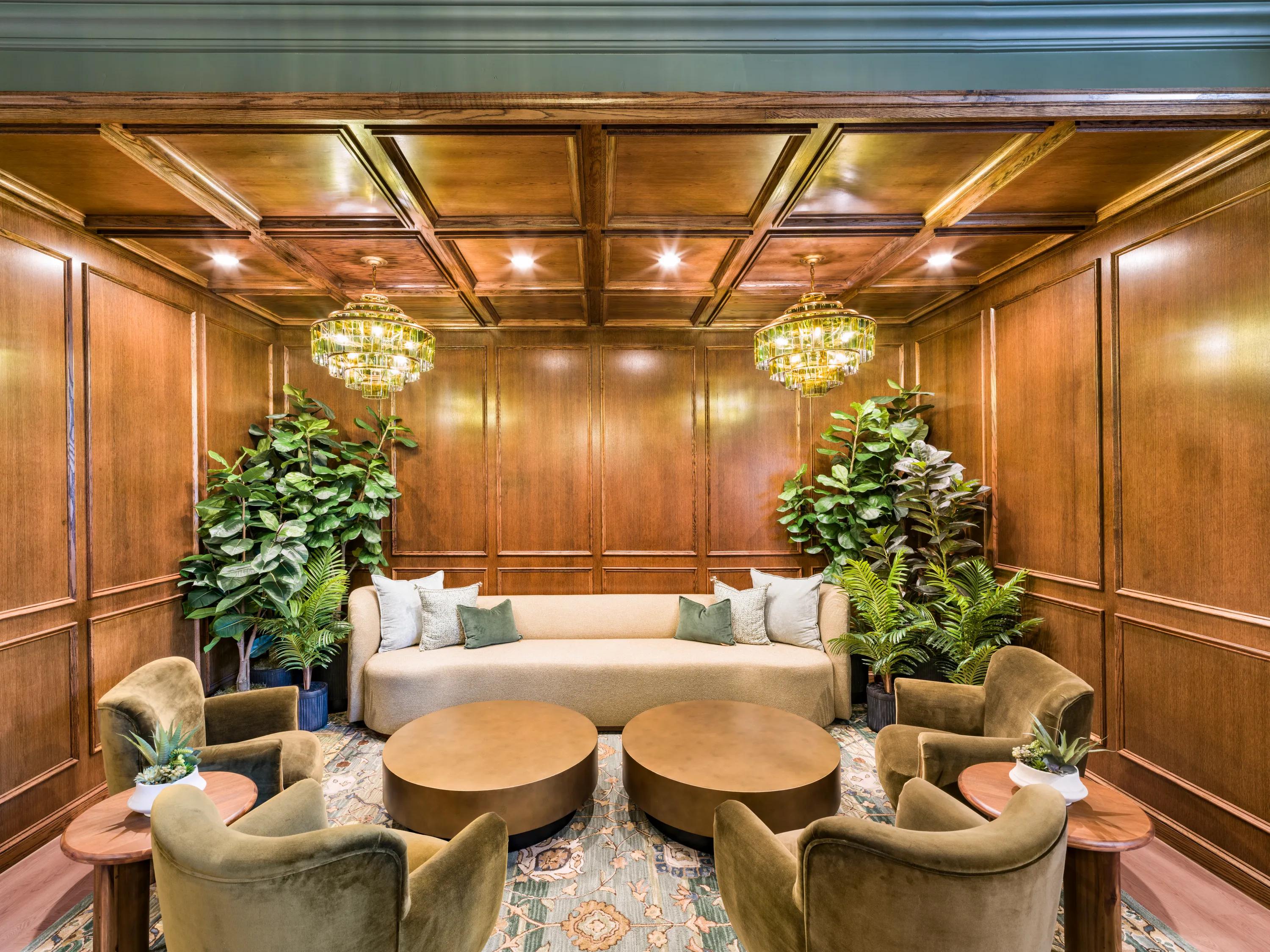 Parlor lounge with rich wood paneling community clubroom modera walsh heights apartments in aledo tx