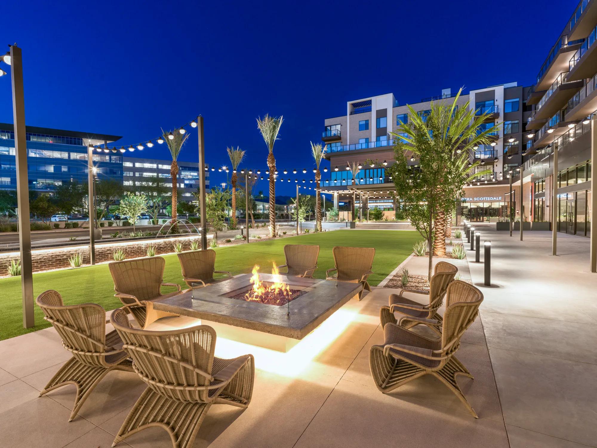plaza at night with seating and turf with retail modera scottsdale apartment homes for rent in az
