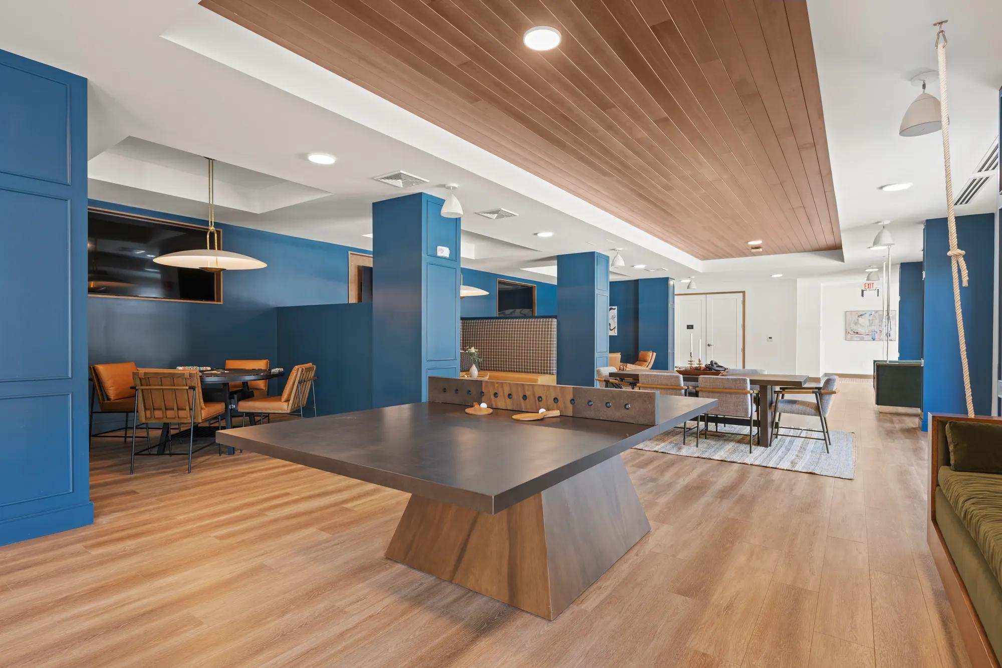 game room with high end tables and equipment at modera newton apartment homes for rent in ma