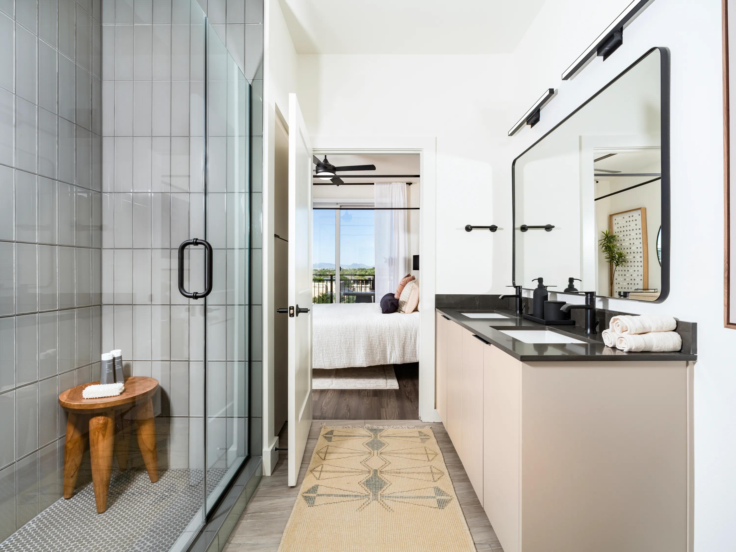 glass enclose showers and black quartz countertops on double vanity in bathroom modera kierland apartments homes for rent in scottsdale z
