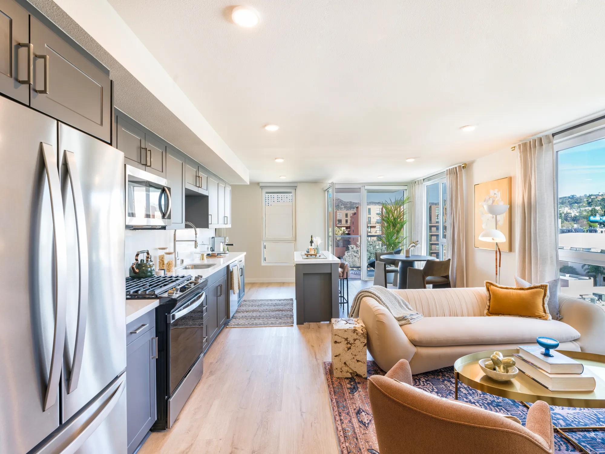 spacious floor plans with oversized windows and wood style flooring
