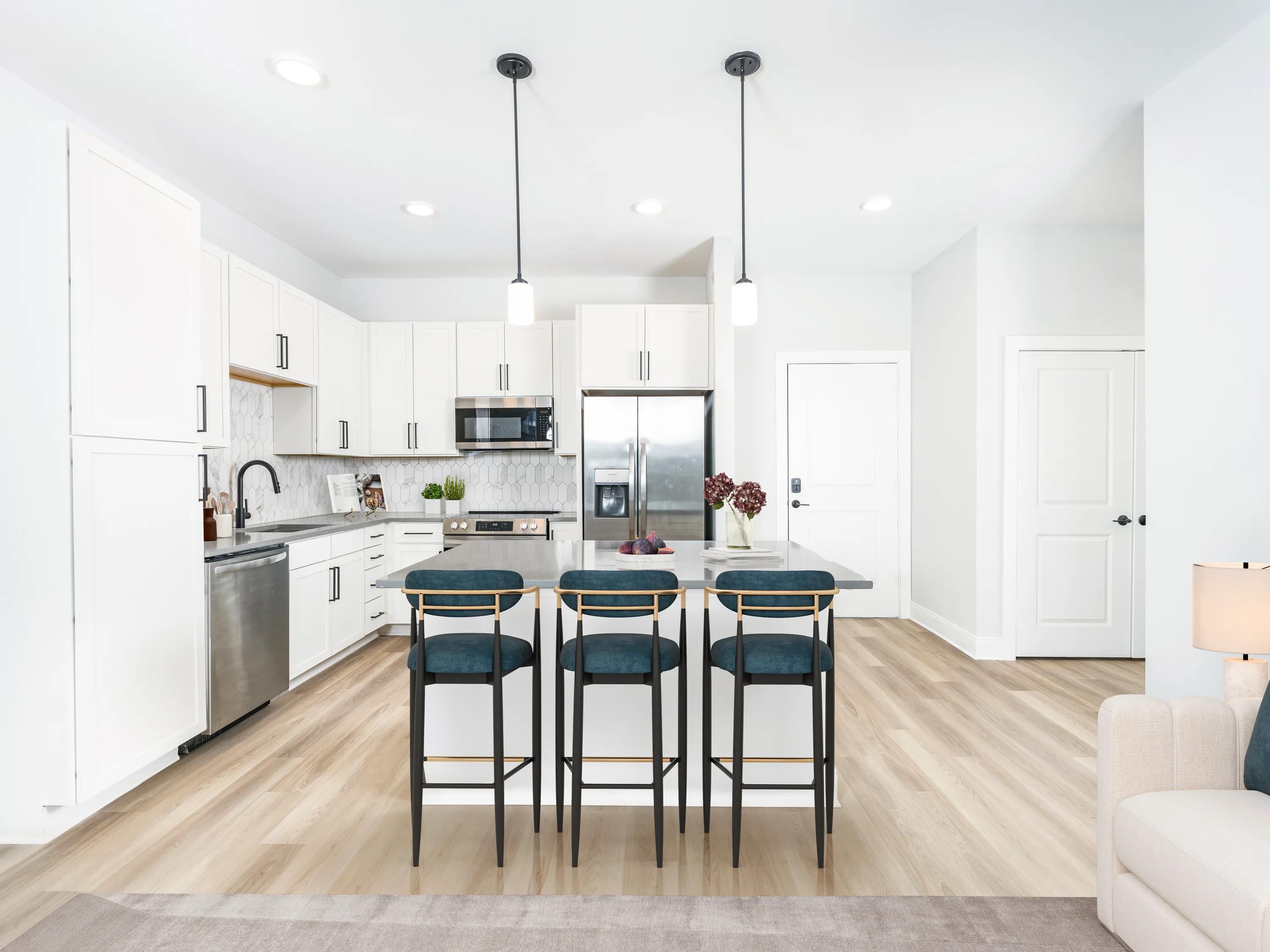 pednant lighting in kitchen with island and white cabinetry modera liberty row apartment homes for rent in in charlotte nc