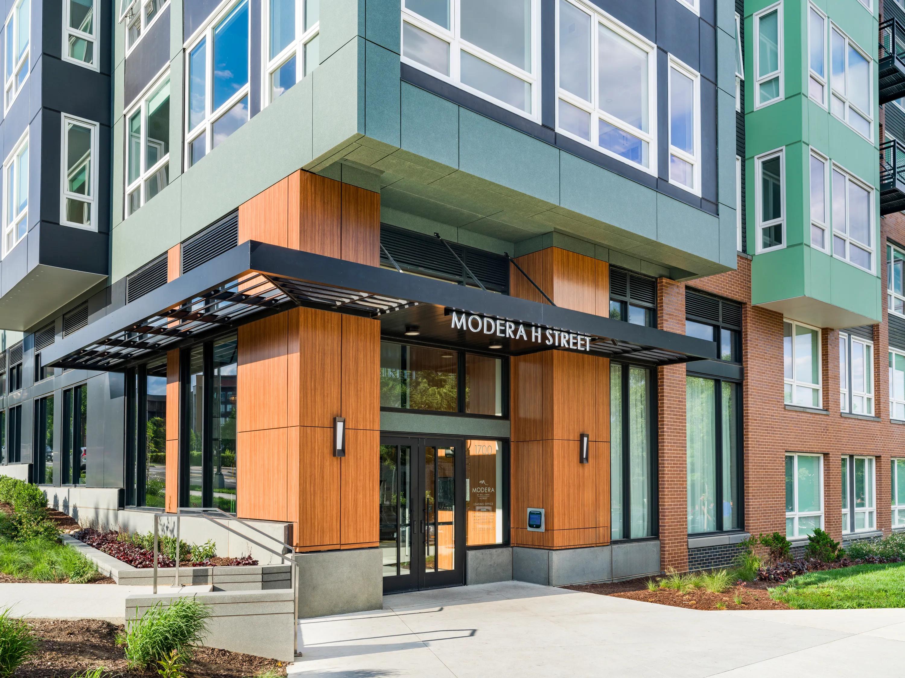 evening exterior building with adjacent streets modera h street apartment homes for rent in washington dc
