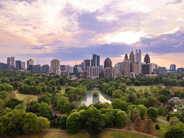 city view from large park with body of water modera parkside apartment homes for rent in atl ga