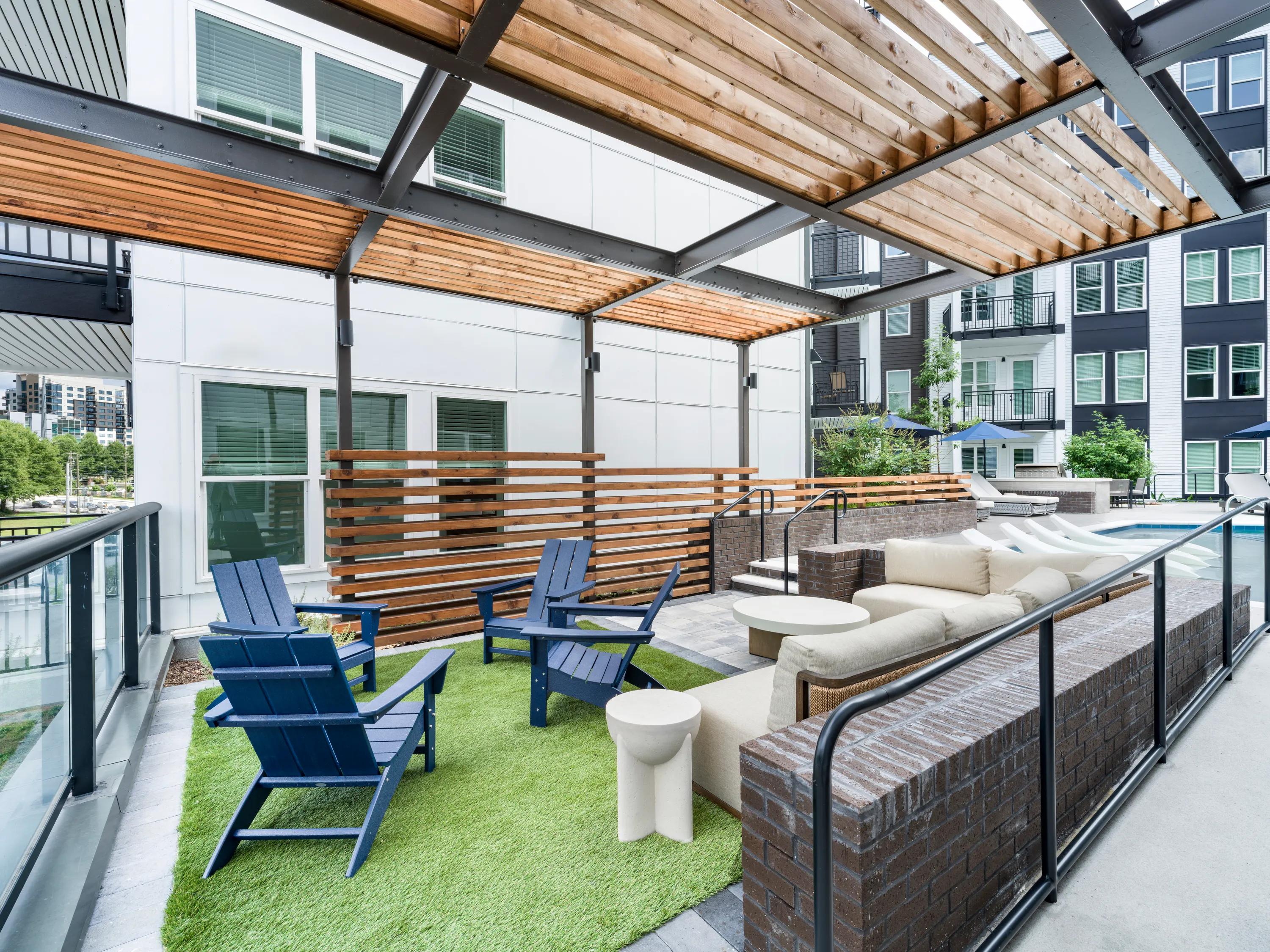 Multiple outdoor courtyards with grilling areas and lounge seating modera westside trail apartments in atlanta ga