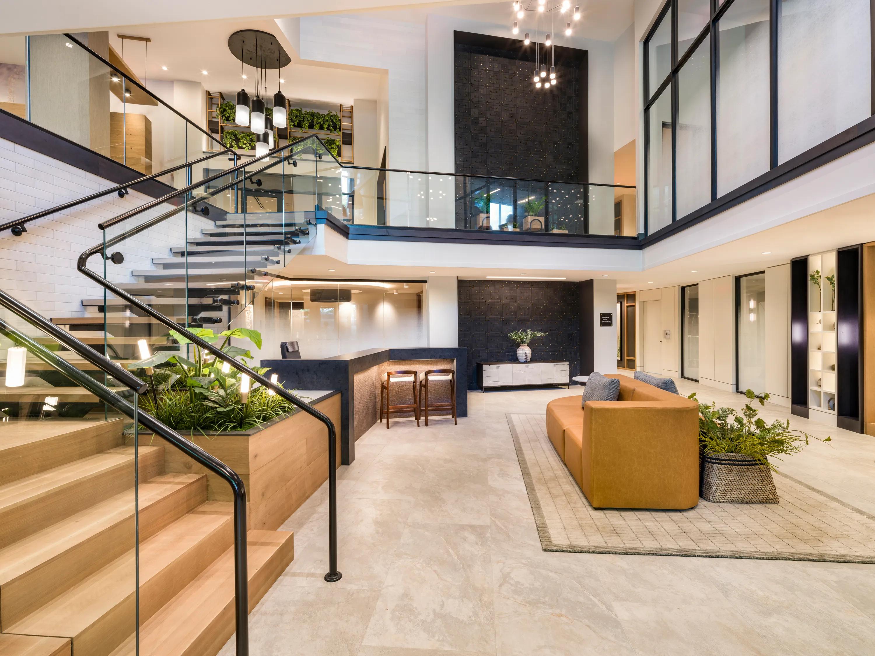 staircase leading down to open common space with modern furniture at modera falls church apartment homes for rent in va