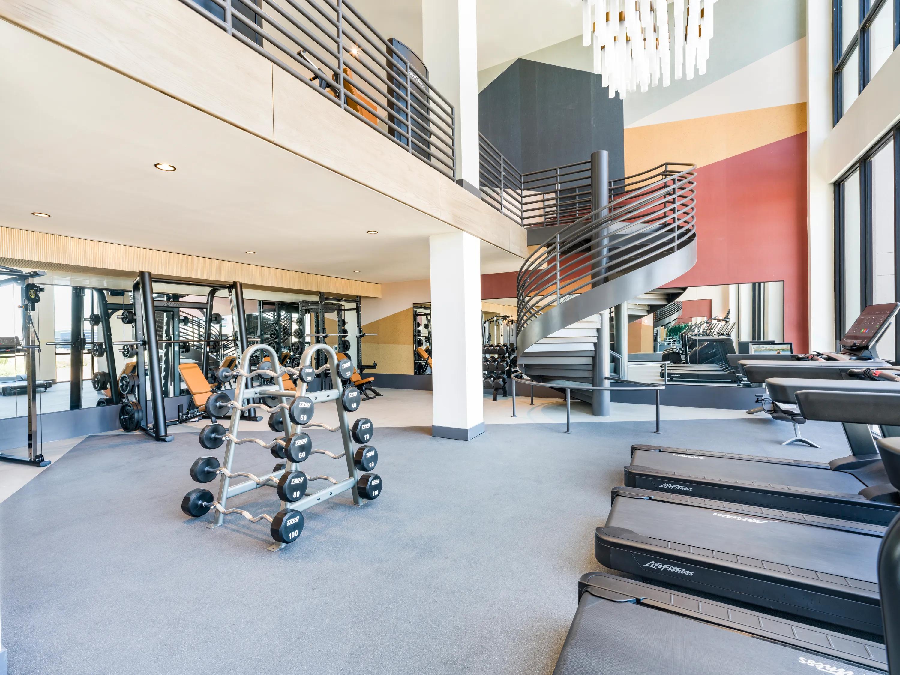 Club-quality fitness studio with TRX system, smart bikes, and fitness on-demand