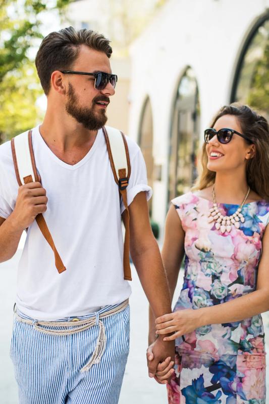 young couple walking outside modera newton apartments in newton ma