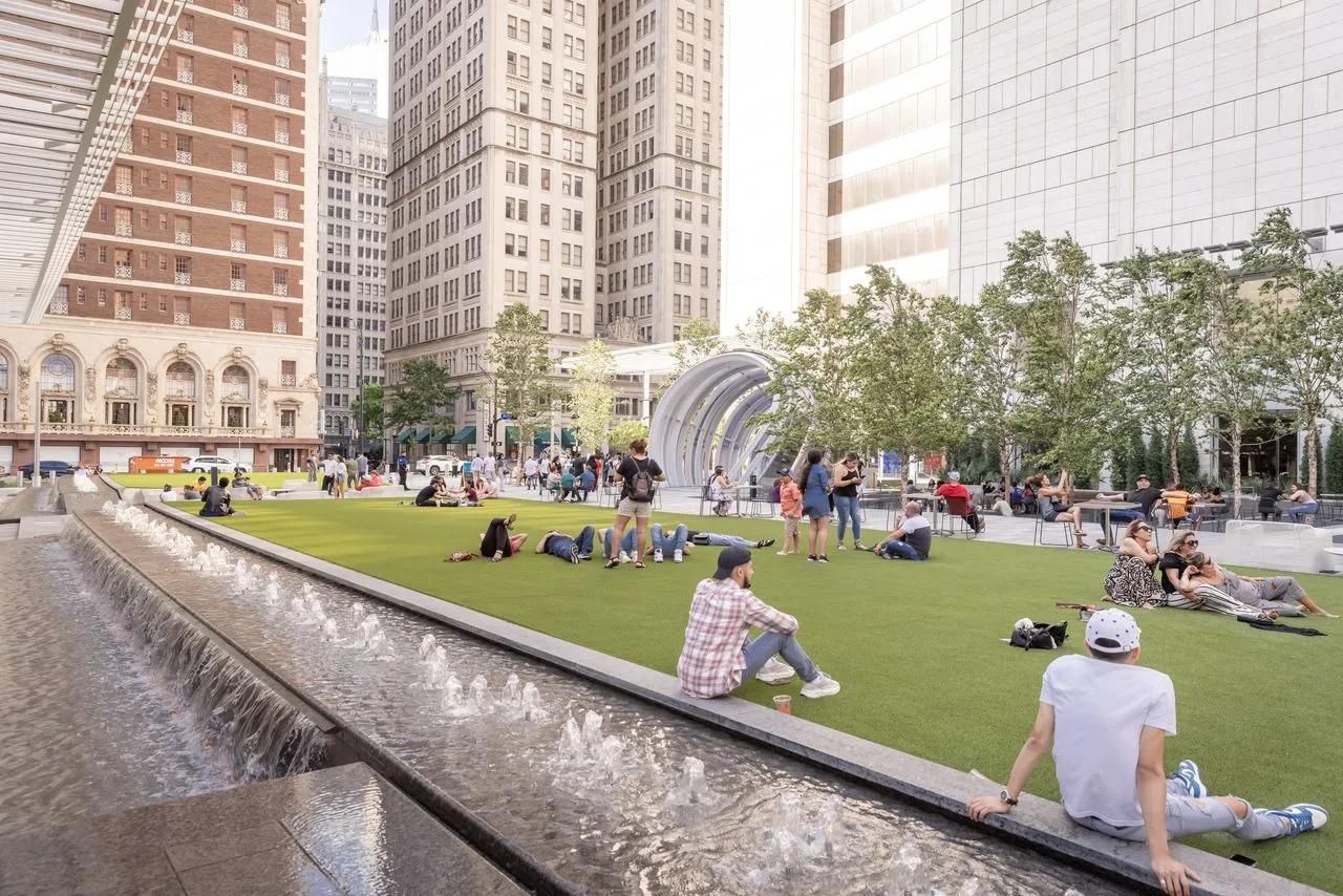 people sitting on lawn at att discover district dallas tx modera st paul apartments